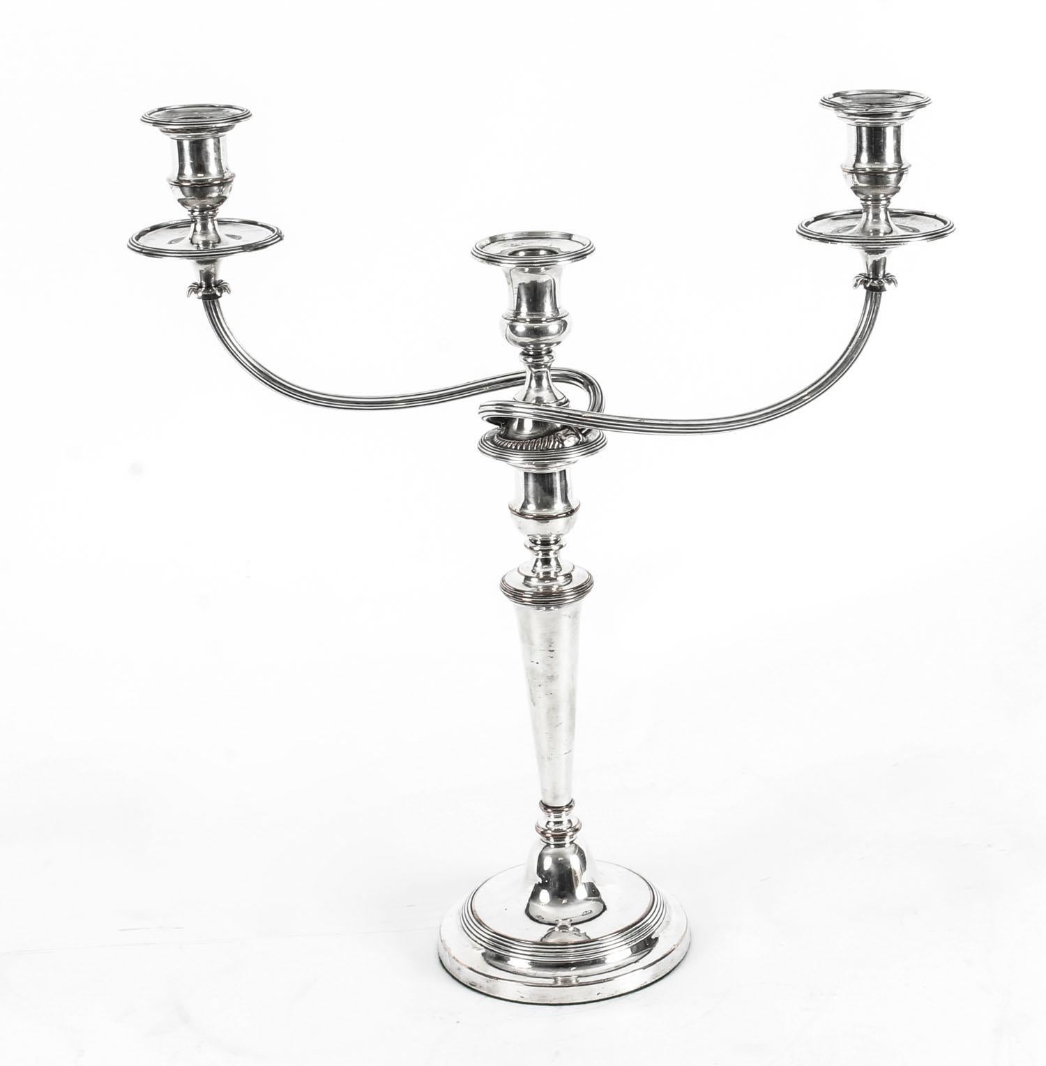 This is a stunning pair of antique English Old Sheffield silver on copper, three light, two-branch table candelabra, circa 1780 in date, and bearing the 