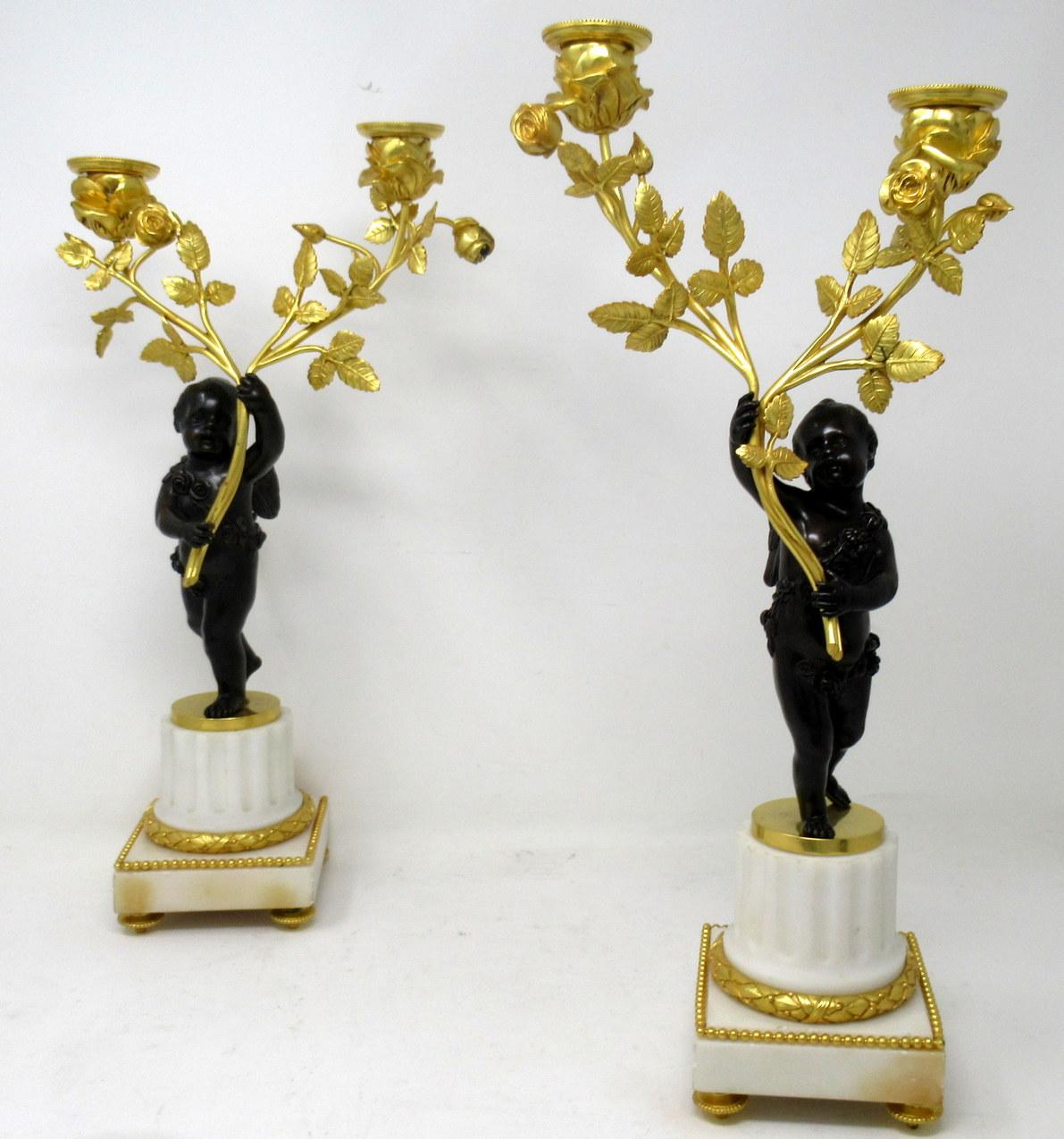 A very fine quality pair of French Louis XV inspired patinated and gilt bronze figural twin branch candelabra of good size proportions (see last image in-situ) depicting Bacchanal Figures of standing Winged Cherubs or Putto. Both with finely sculped