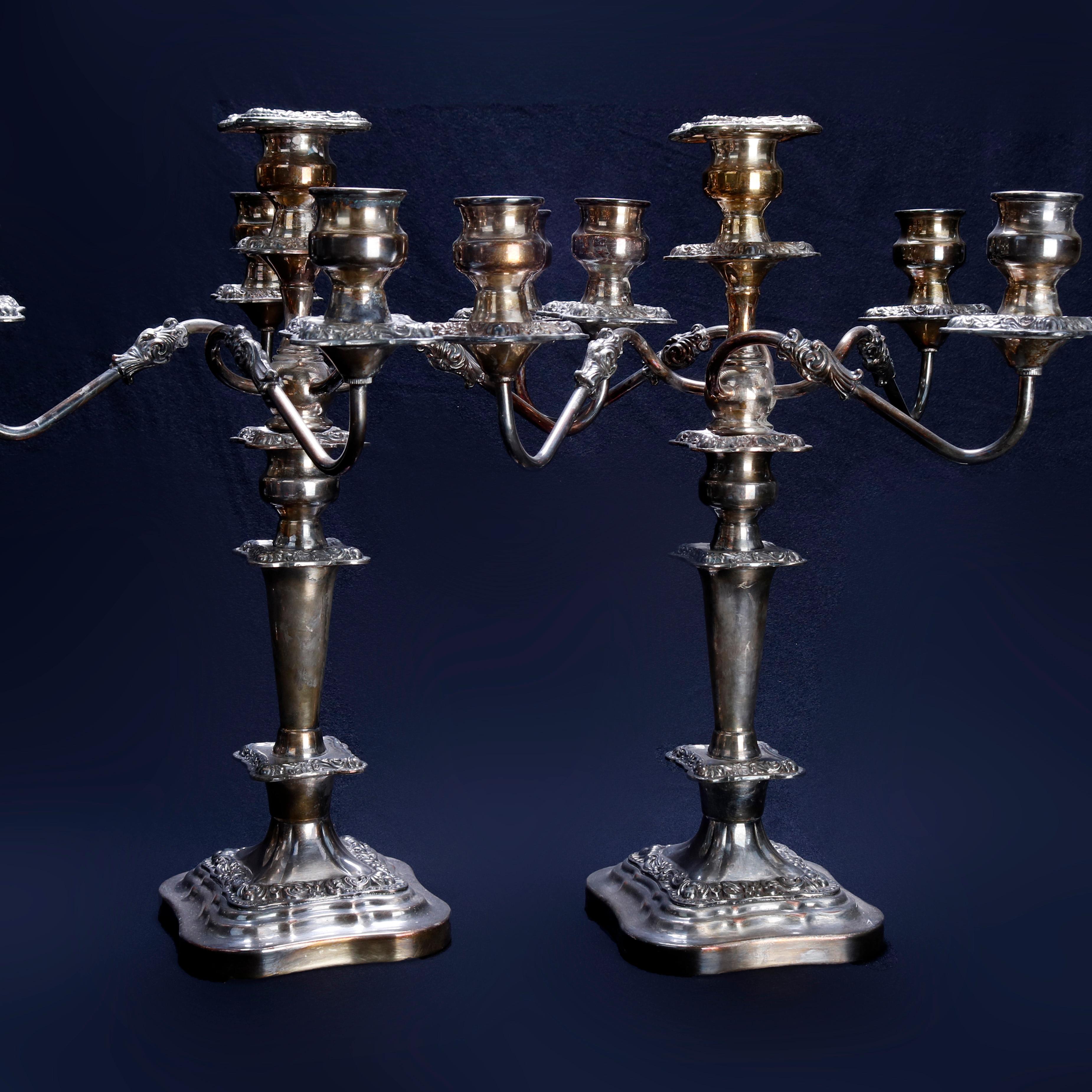 An antique pair of candelabra by Gorham offers silver plate balustrade construction with four scroll form arms surrounding central candle socket seated on shaped and stepped base with foliate decoration, circa 1920

Measures: 18