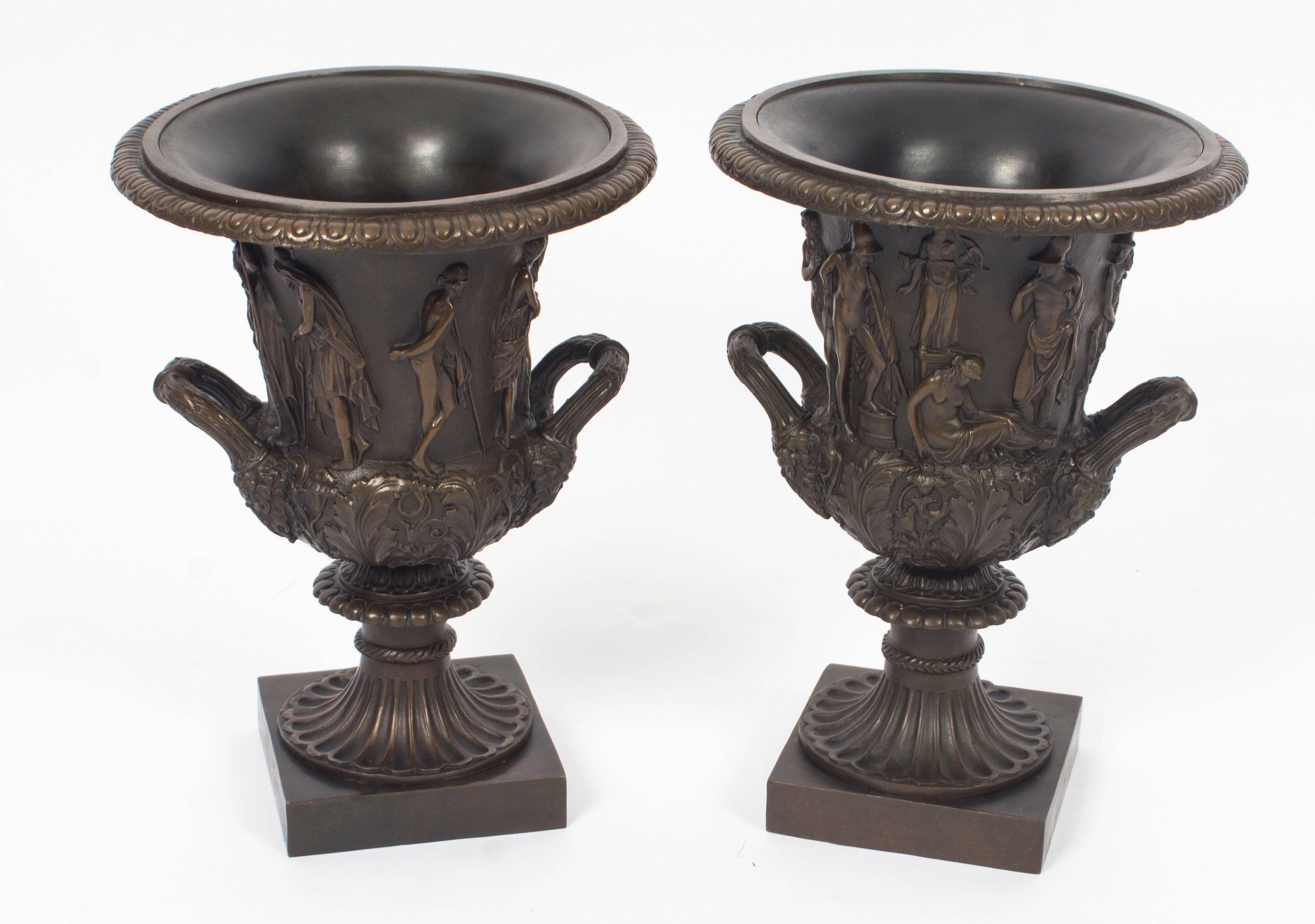 A superb antique pair of Grand Tour bronze Borghese Campana urns, circa 1870 in date.

This pair of patinated bronze campana urns are after the Borghese models with classical relief decoration with beaded rims and mythological figures on a