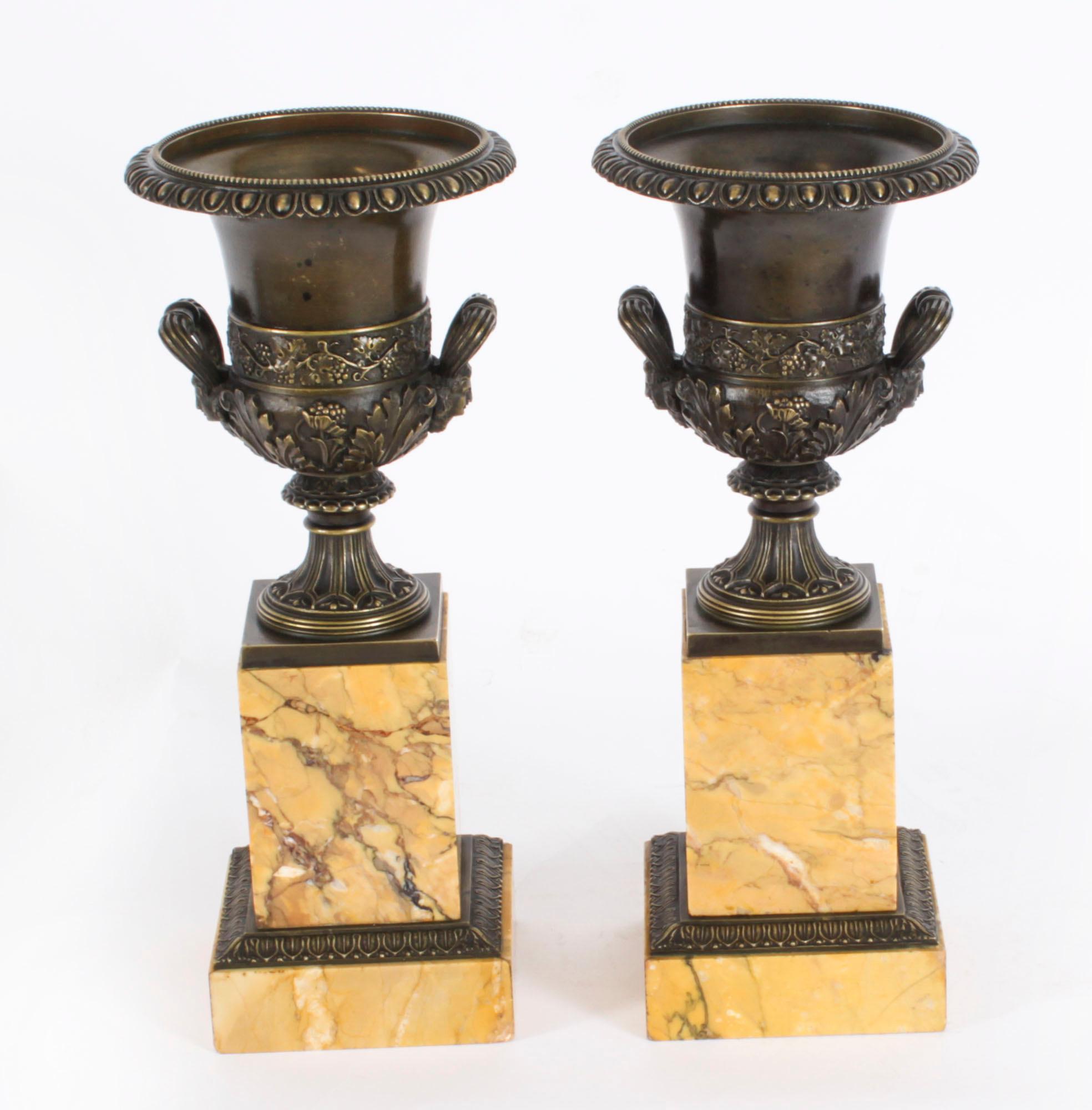 A superb antique pair of Grand Tour bronze and Siena marble Borghese Campana urns, circa 1870 in date.

This pair of patinated  bronze campana urns are after the Borghese models with classical  relief decoration with beaded rims on a pedestal base