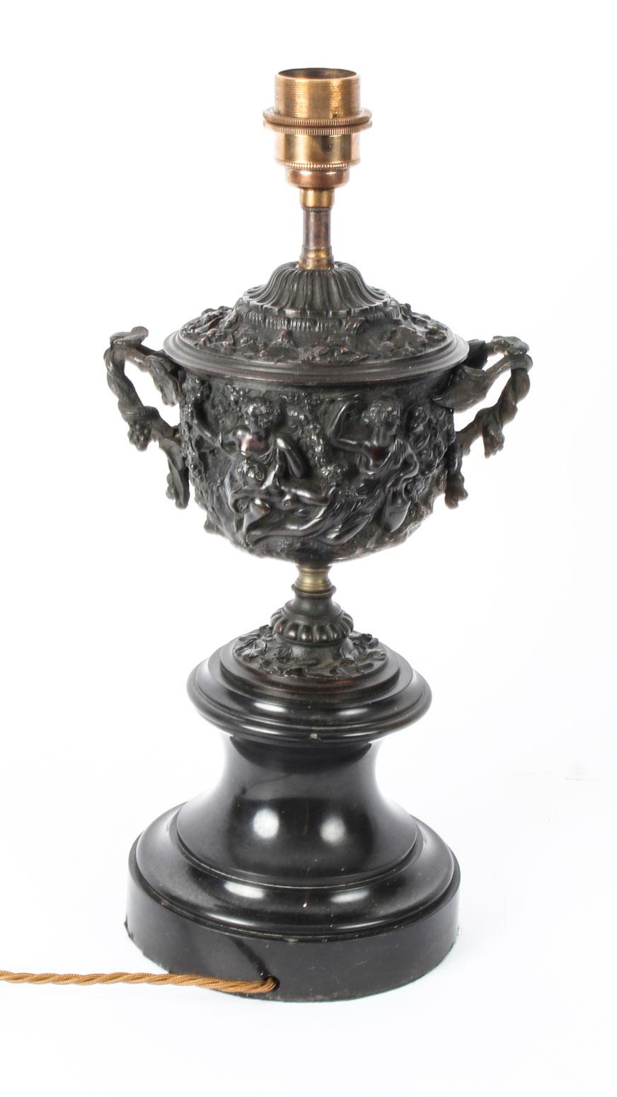 A superb antique pair of Grand Tour bronze twin handled urns, converted to lamps, circa 1870 in date.

This striking pair of twin handled bronze urns have decorative relief decoration with classical figures, are mounted on marble socles, and have
