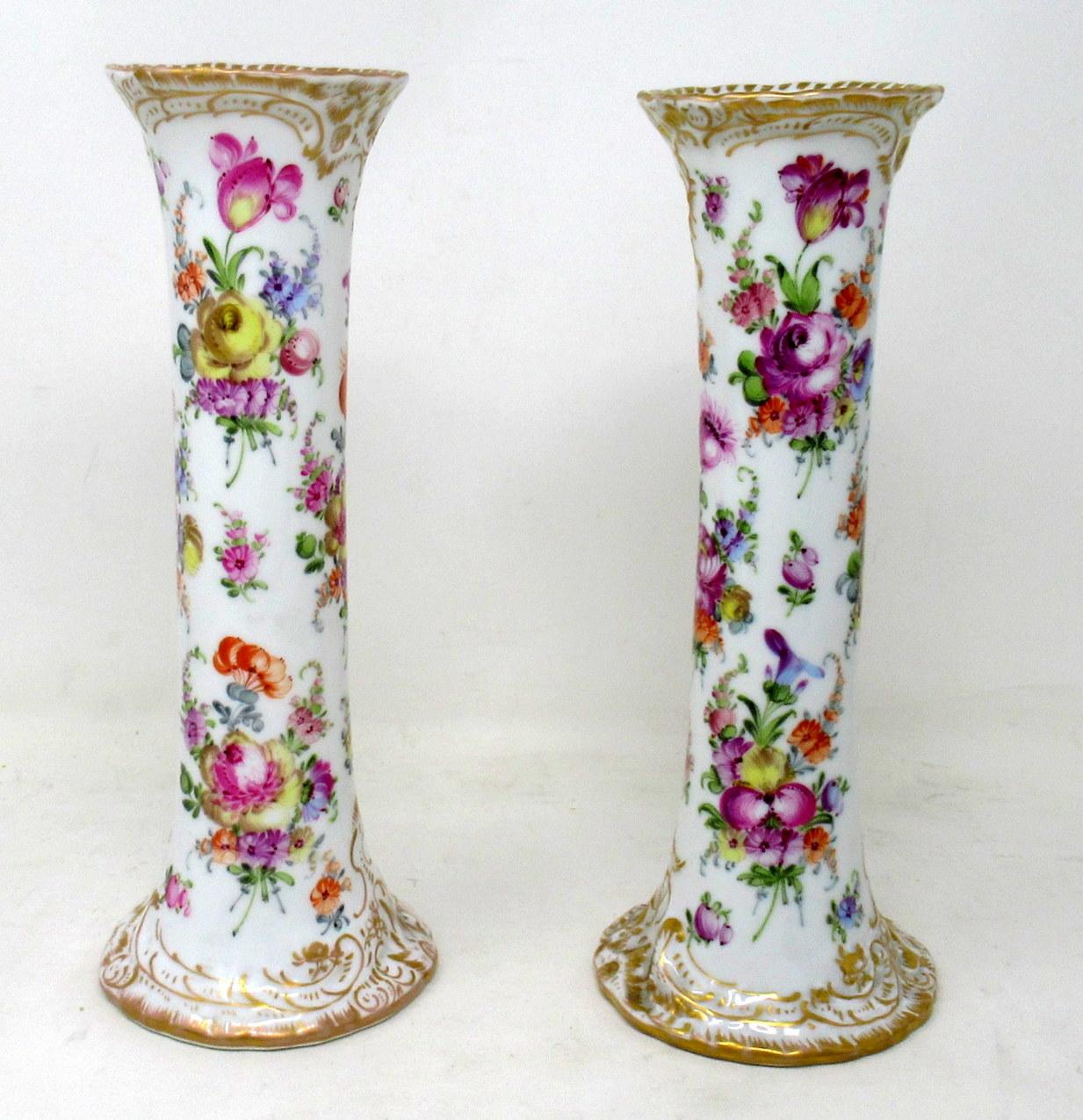 Fine pair of hand painted German hard paste dresden porcelain tall flaring trumpet mantle or desk vases, late nineteenth early twentieth century.

Each with a spiral body rising from a circular spreading gilt base to a flaring rim. The entire