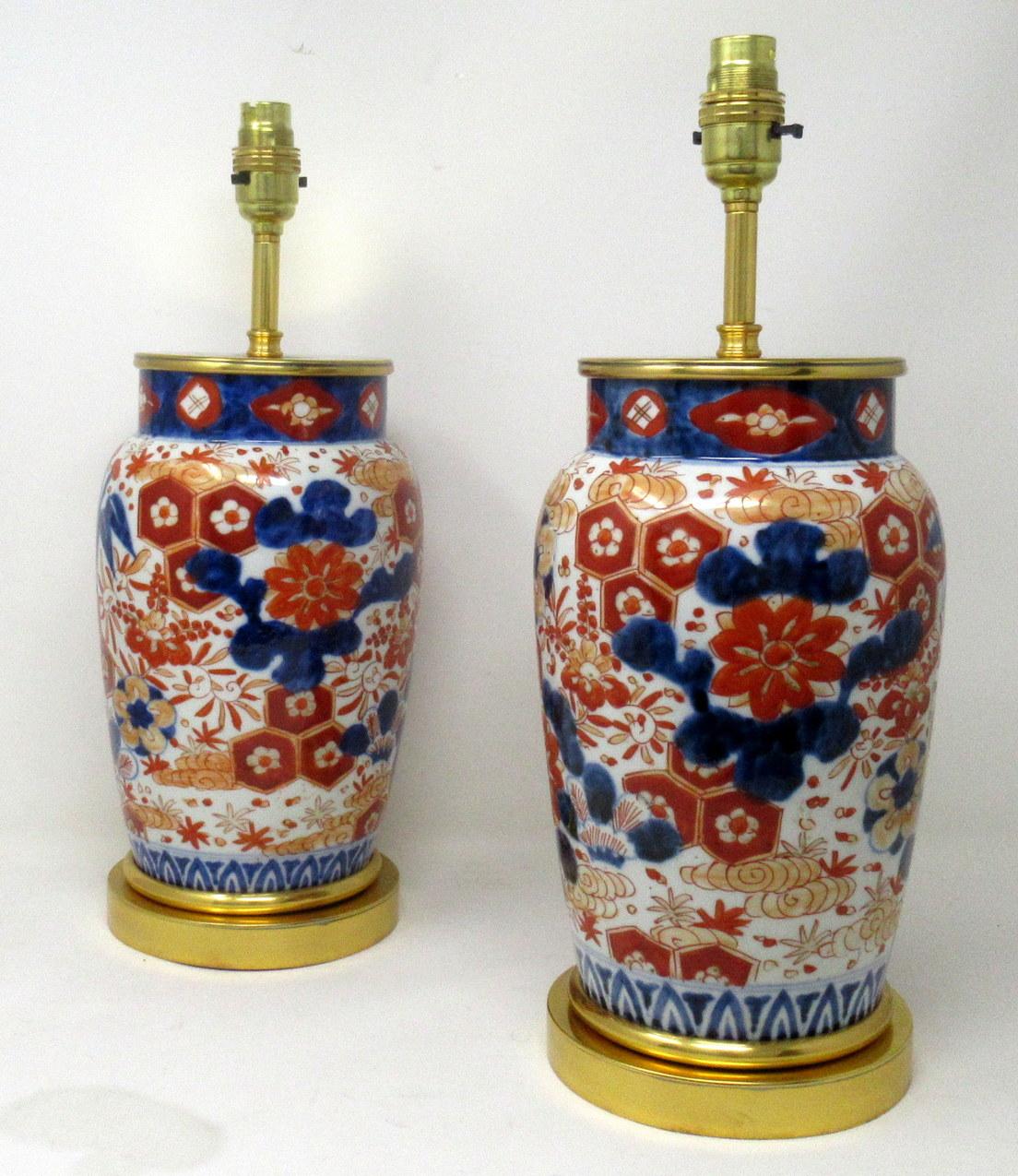 Stunning Pair Traditional Japanese Imari Bulbous Form Porcelain Vases of generous proportions, now converted to a pair of electric Table Lamps, complete with ormolu heavy gauge stepped circular bases and later ormolu mounts. First half of the