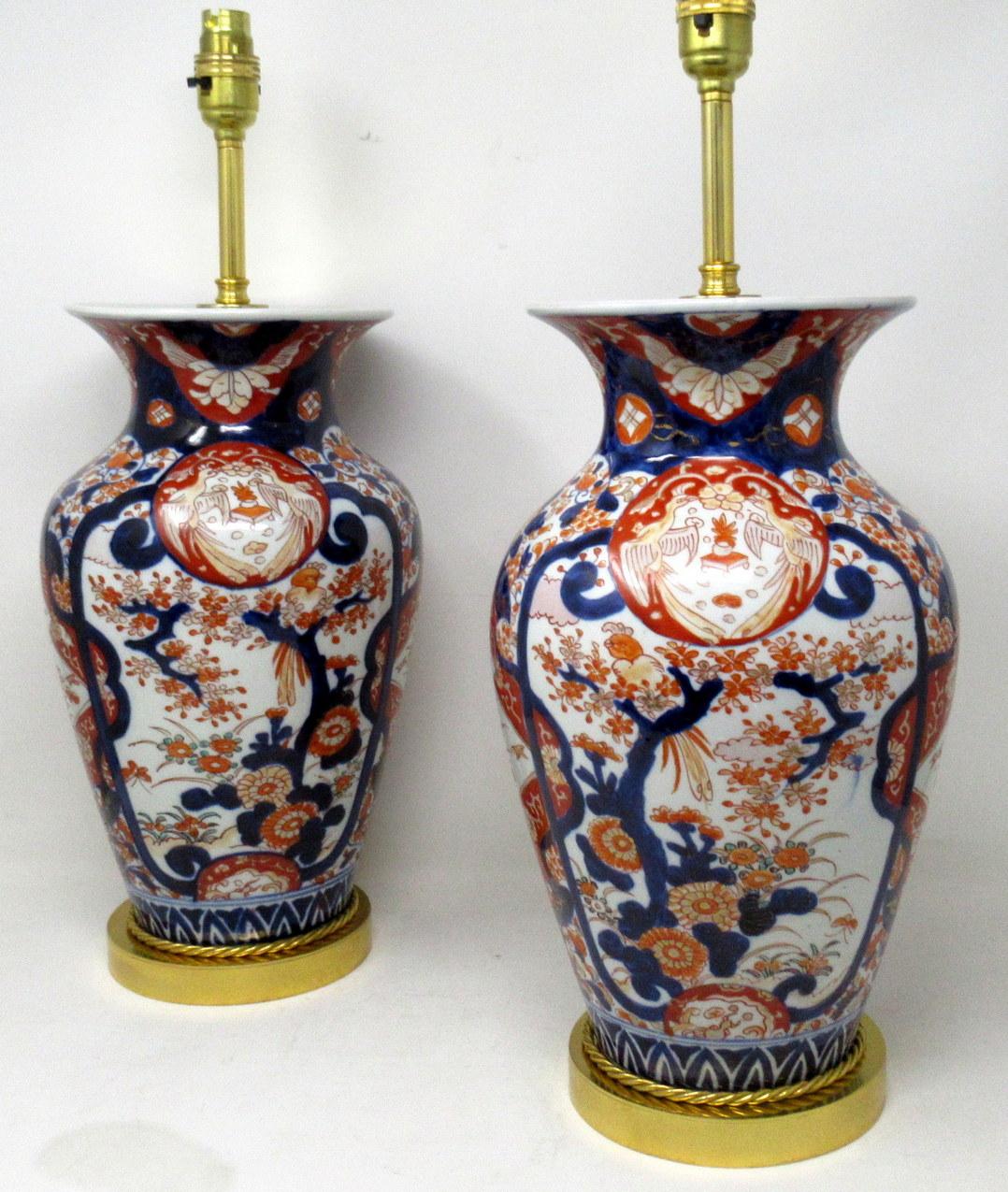 Stunning pair traditional Japanese Imari Bulbous form porcelain vases of quite large proportions, now converted to a pair of electric Table Lamps, complete with ormolu heavy gauge stepped circular bases with attractive rope edge detailing and later