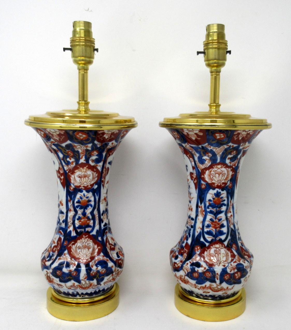 Stunning pair traditional Japanese Imari circular form hand painted Porcelain Vases of quite compact proportions, now converted to a Pair of Electric Table Lamps. First half of the Nineteenth Century. 

The main outer waisted porcelain ribbed body