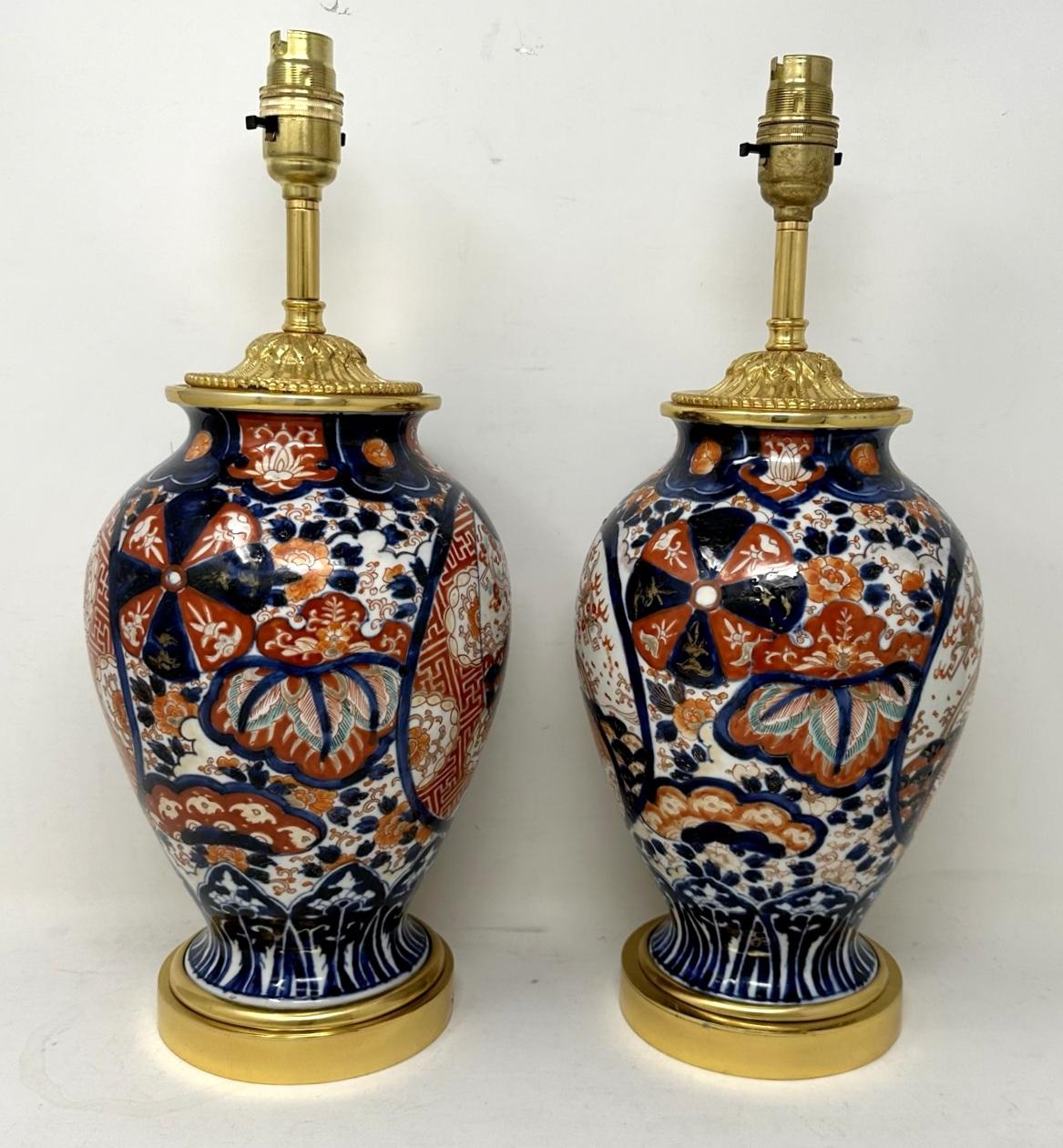 Stunning pair traditional japanese imari bulbous form porcelain vases of generous proportions, now converted to a pair of electric Table Lamps, complete with ormolu stepped circular bases and later highly decorative ormolu dome shaped mounts. Last