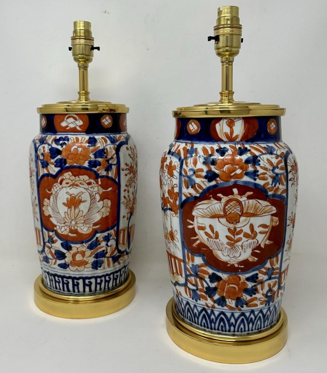 Stunning Pair Traditional Japanese Imari Bulbous Form Porcelain Vases of generous proportions, now converted to a pair of electric Table Lamps, complete with ormolu stepped circular bases and later highly decorative ormolu dome shaped mounts. Last