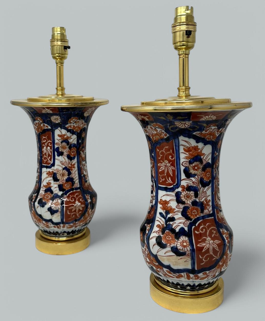 Stunning Pair Traditional Japanese Imari circular form hand painted Porcelain Vases of quite generous proportions, now converted to a Pair of Electric Table Lamps. First half of the Nineteenth Century.   
The main outer waisted porcelain ribbed body