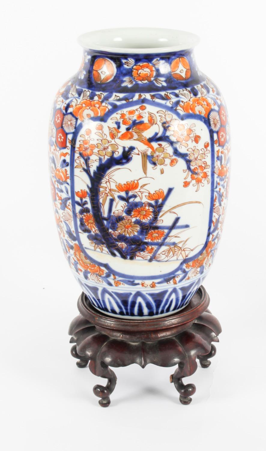 This is a decorative pair of Japanese Imari jars on stands, circa 1870 in date.
 
The pair of bulbous shape vases feature matching stunning Japanese decoration in the traditional Imari colour scheme of orange, blue and white with hand finished