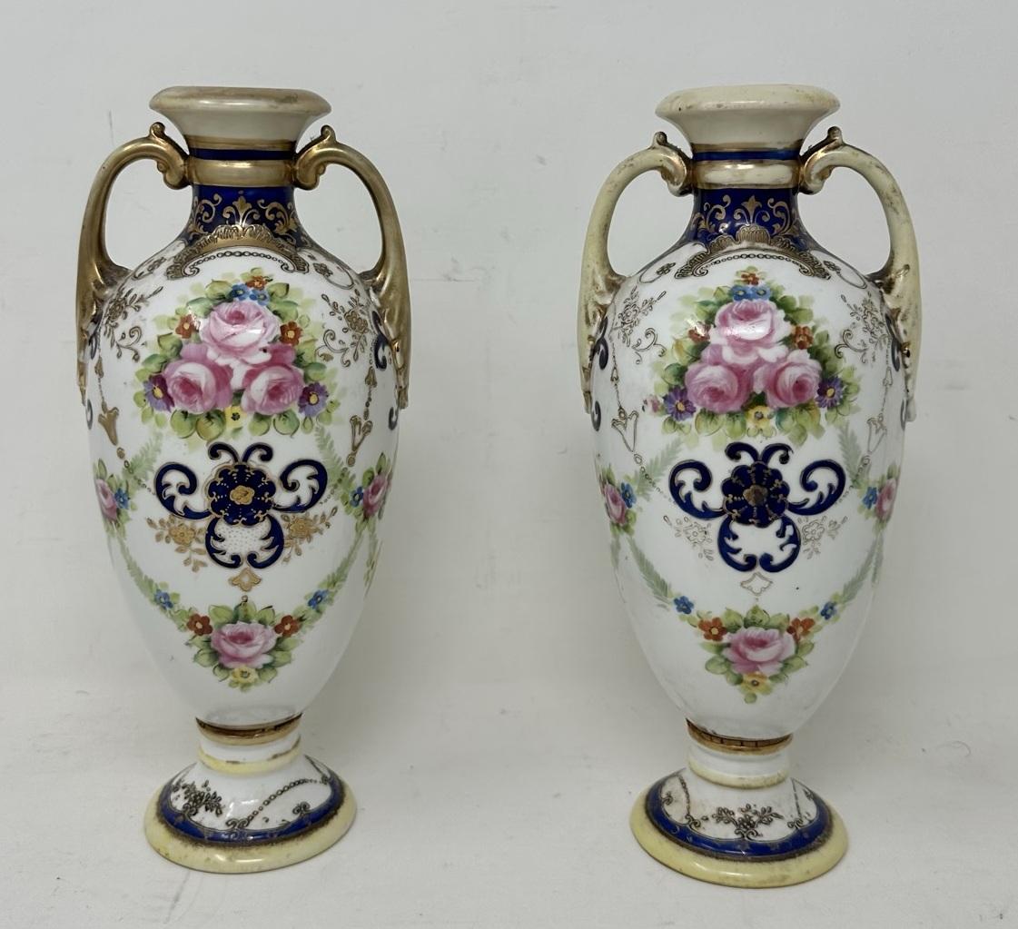 An Elegant Fine Pair Japanese Noritake Hand Painted Porcelain Vases of outstanding quality. First quarter of the Twentieth Century, late Meiji period.  

Of ovoid form, each hand painted with old Summer Pink Roses on an off-white and cobalt blue