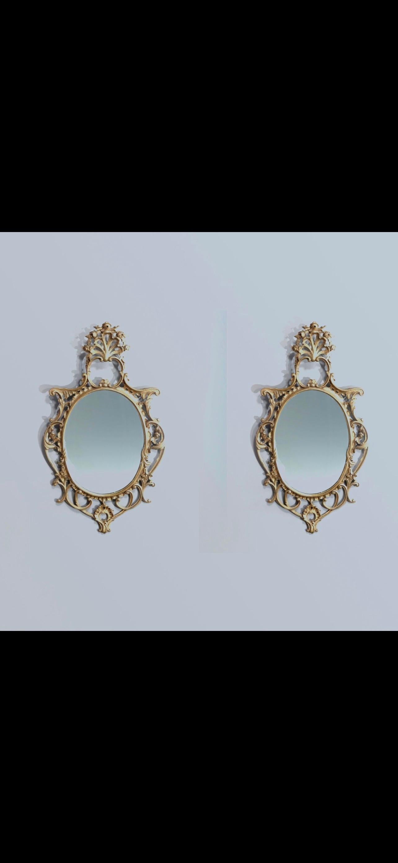 An antique and large French Louis XIV wall mirrors offer pierced giltwood frames with stylized shell crest and scroll, foliate and floral surrounds, 19th century
 
Measures: 44.5