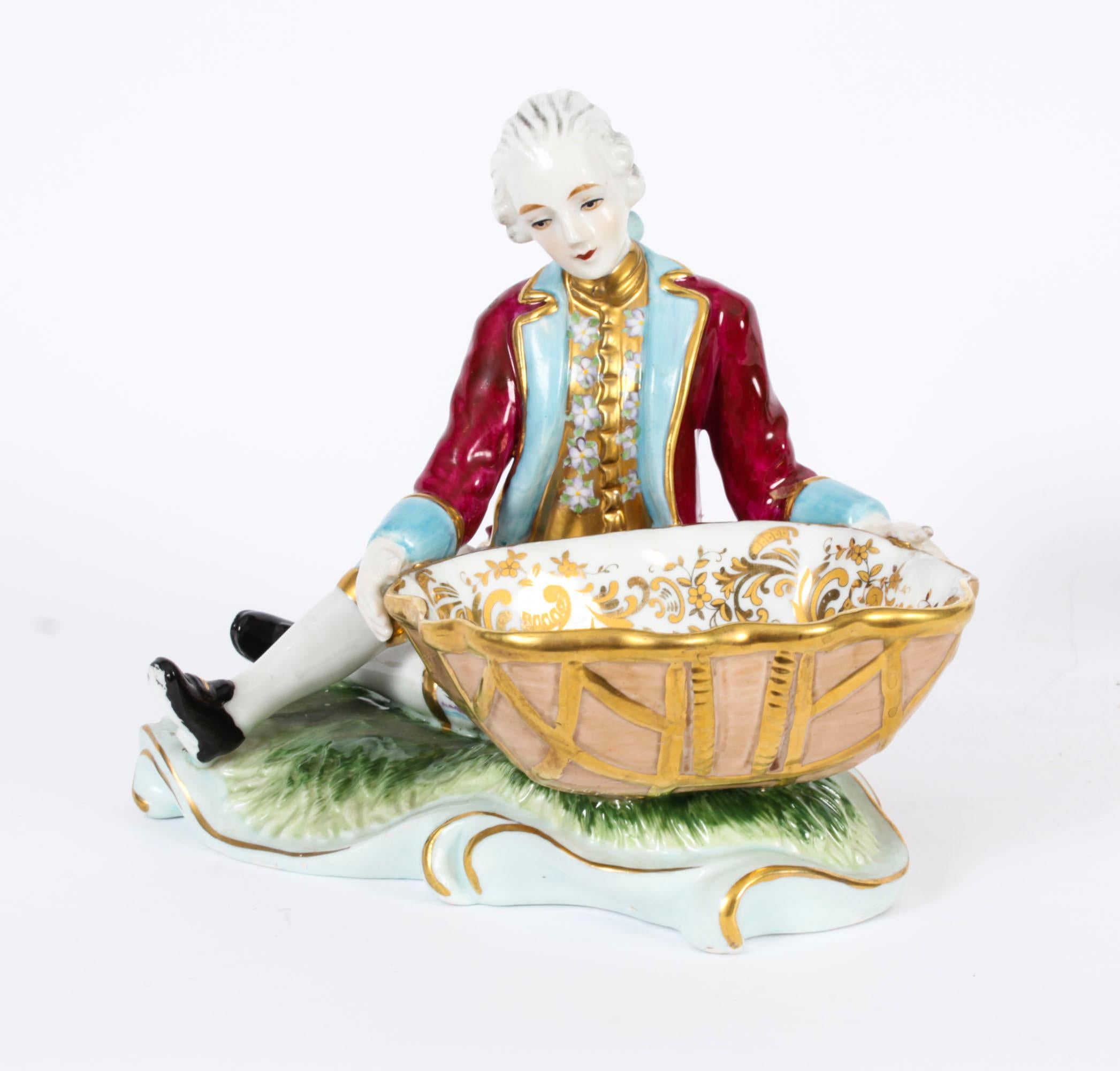 This is a beautiful  antique pair of Meissen Dresden porcelain table salts, circa 1880 in date.

The couple dressed in period costume each holding a bowl for your salt, both with beautiful hand painted decoration.

With the Meissen underglaze blue