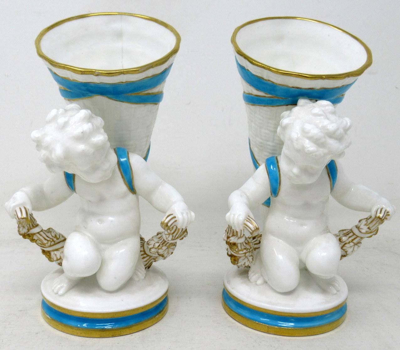 Stunning Example of a pair of English Minton Porcelain Centerpieces or Flower Vases, each modelled as a kneeling cherub carrying a flower vase on its back in the form of a cornucopia kneeling on a naturalistic circular base on a plain platform