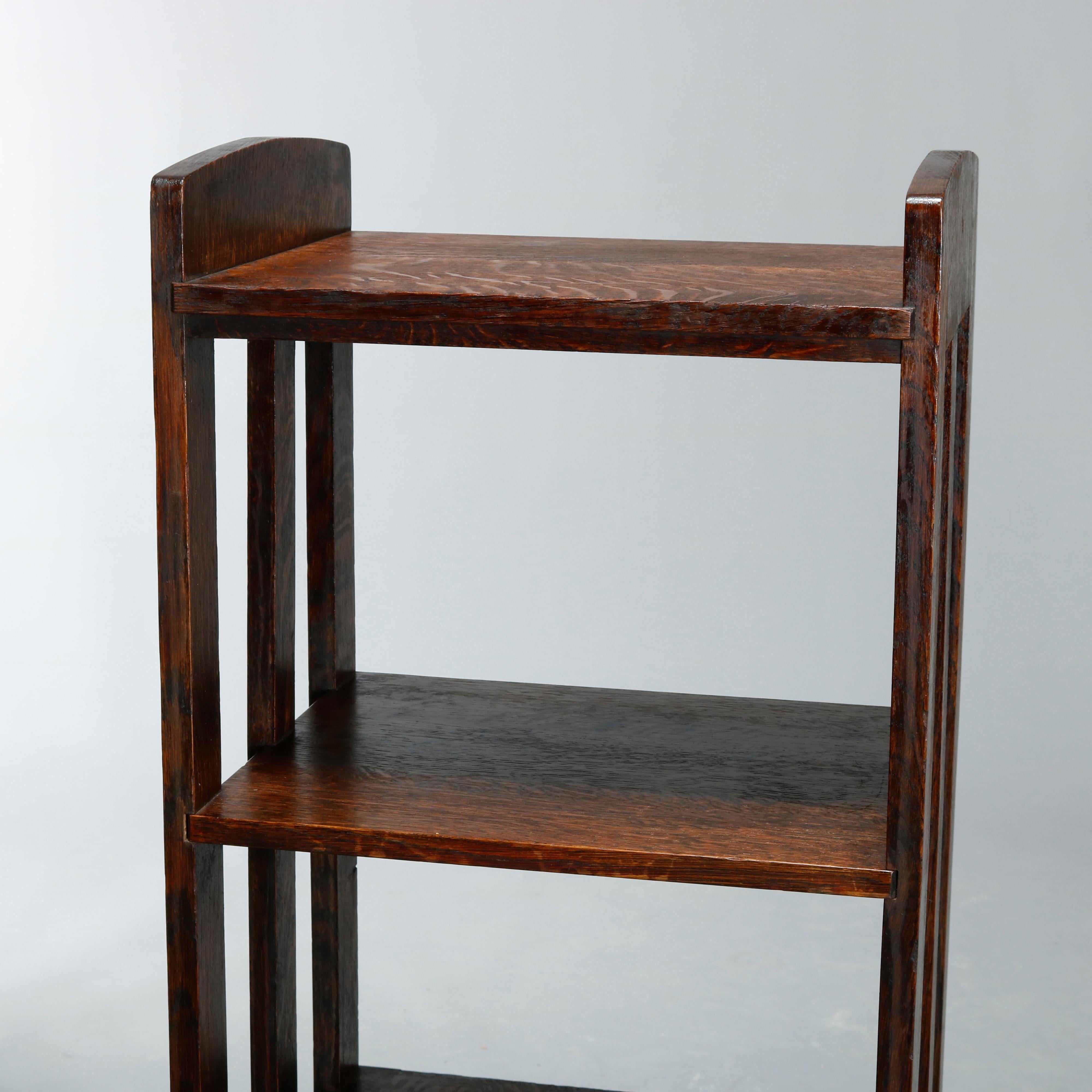 An antique pair of Arts & Crafts mission magazine stands by lakeside crafters offers oak construction with slat sides and three shelves, missing label, circa 1910. 

Measures: 40.5