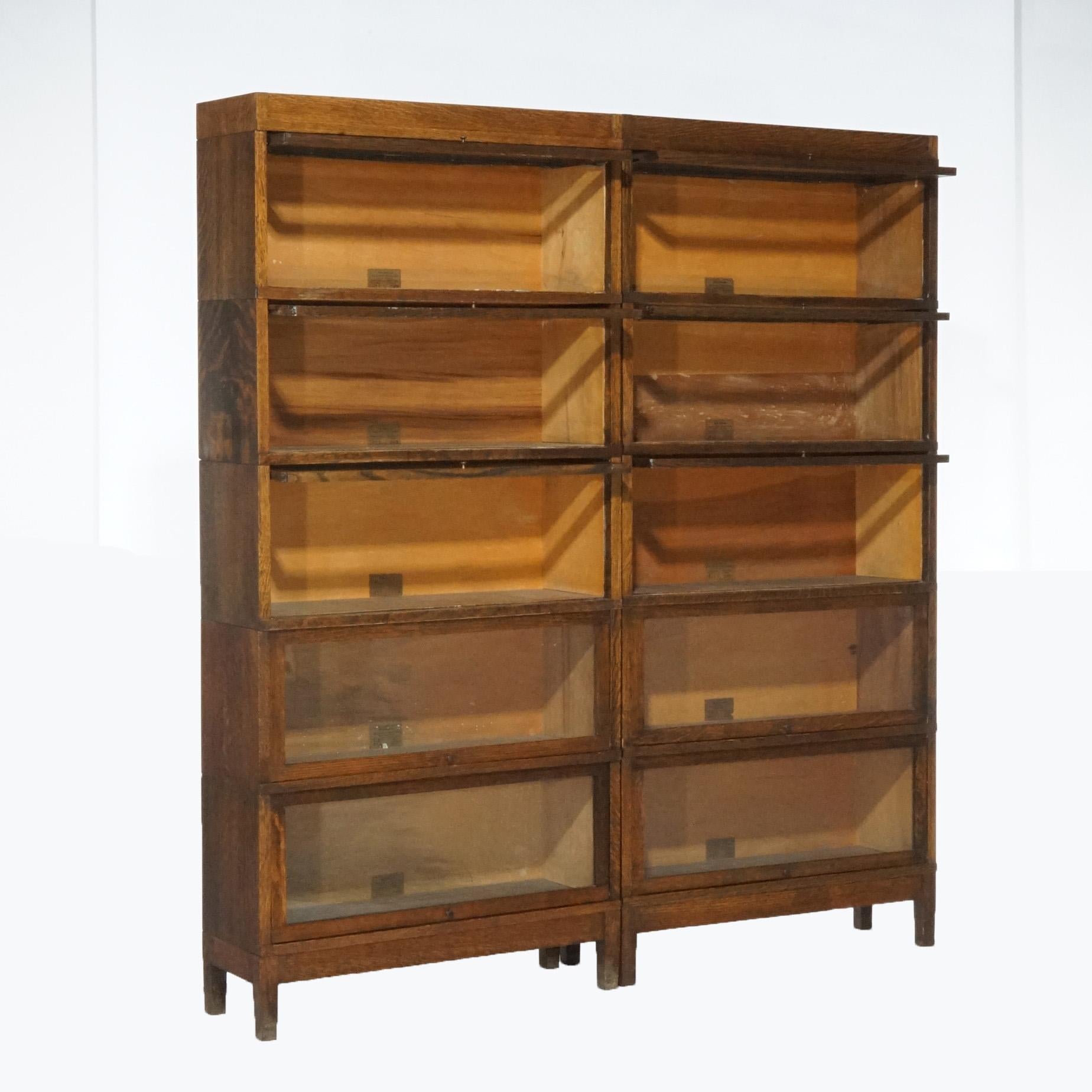 An antique matching pair of barrister bookcases by Globe Wernicke offer oak construction with each case having five stacks with pull out glass doors, raised on straight legs, maker label as photographed, circa 1910

Measures- overall 75.5''H x