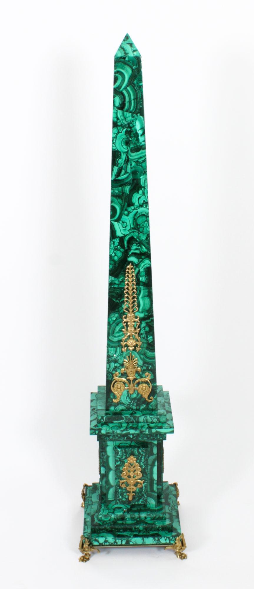 A monumental pair of Neoclassical ormolu mounted malachite obelisks, Circa 1920 in date.
 
The square conforming malachite columns taper to pyramid shapes with applied decorative gilt ormolu mounts.
 
The obelisks stand on malachite stepped