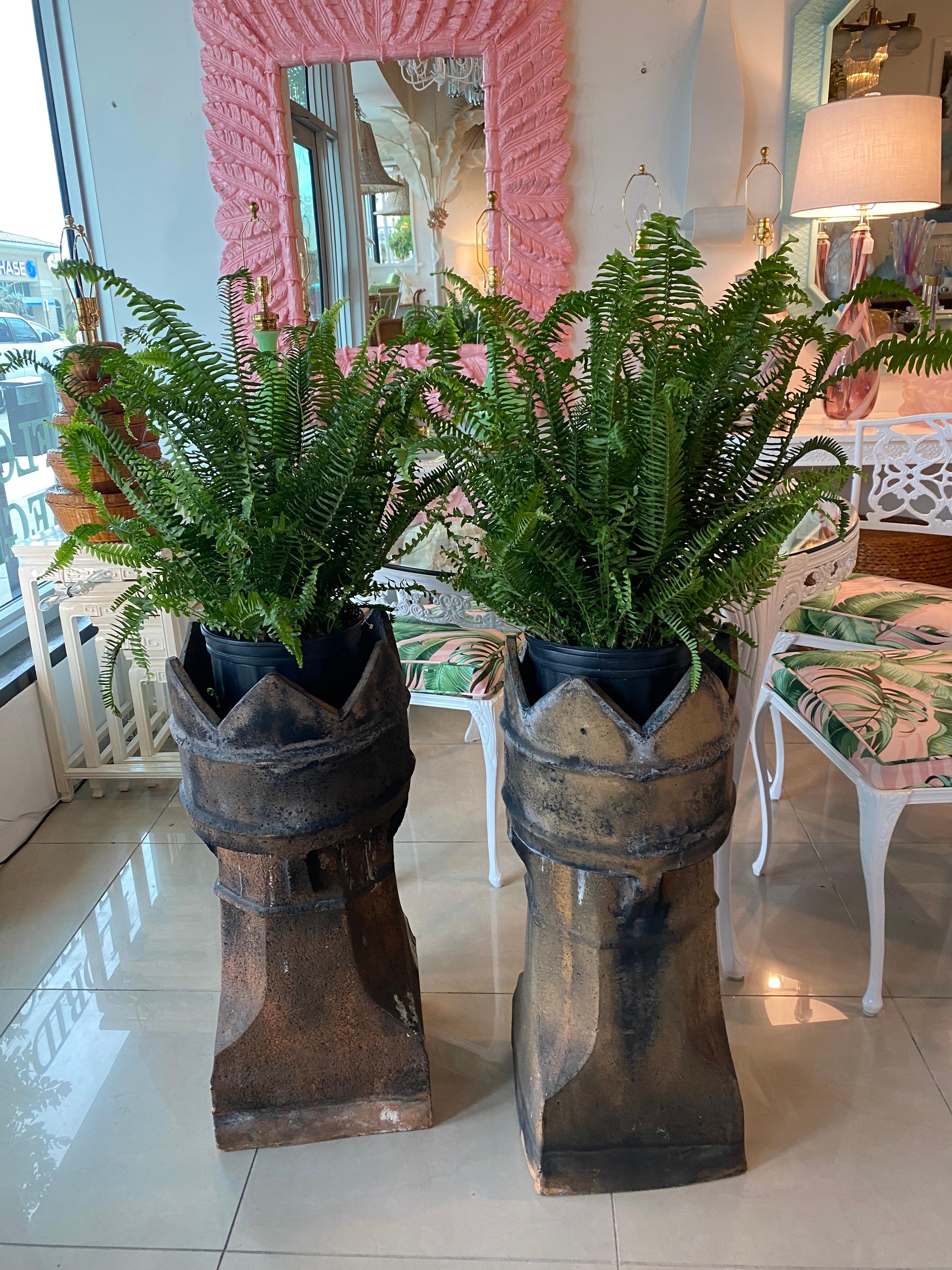 Lovely pair of 1890s English chimney pots with great original patina. I use them as planters as you can see by the picture. I put a terra-cotta saucer on the bottom of each pot and placed the plant in.