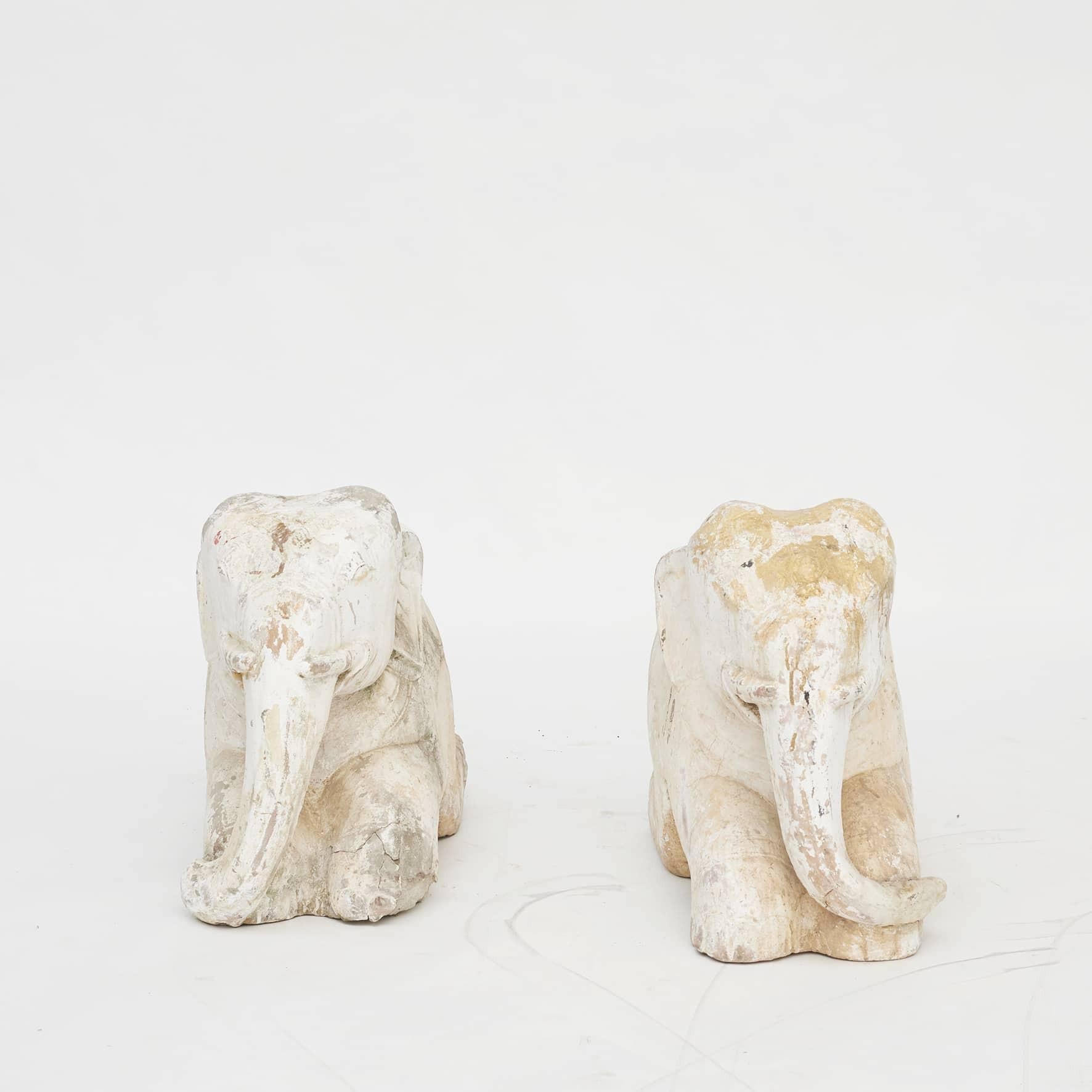 Pair of rare 18th century temple elephants carved in sandstone with chalk and leftovers of gold leaf.
Chalking is used as a surface to bind gold leaf. Originally fully covered with gold leaf.
Elephants have a God status and are the guardians of