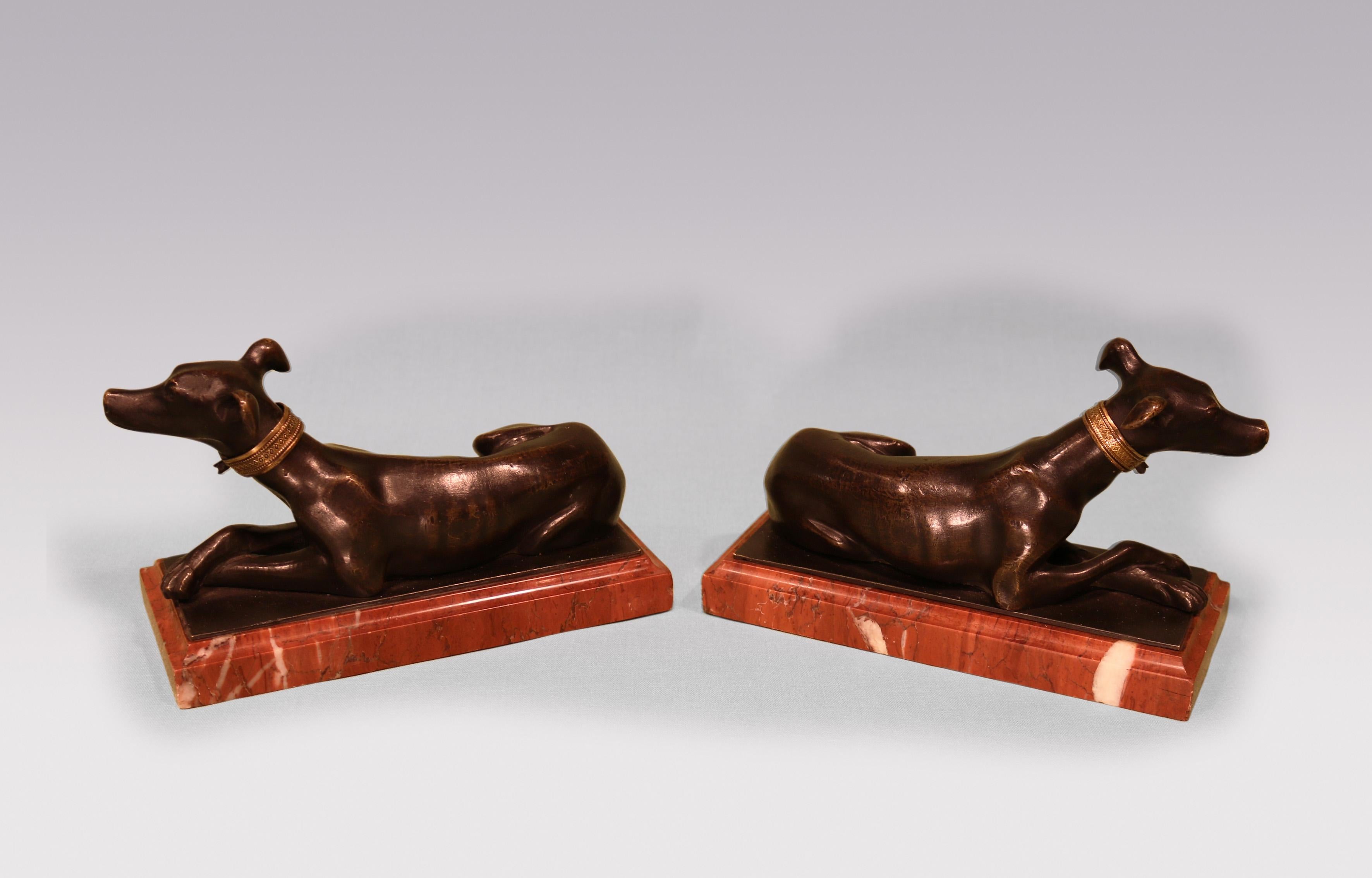 Regency Antique pair of 19th century bronze hounds on red marble bases. For Sale