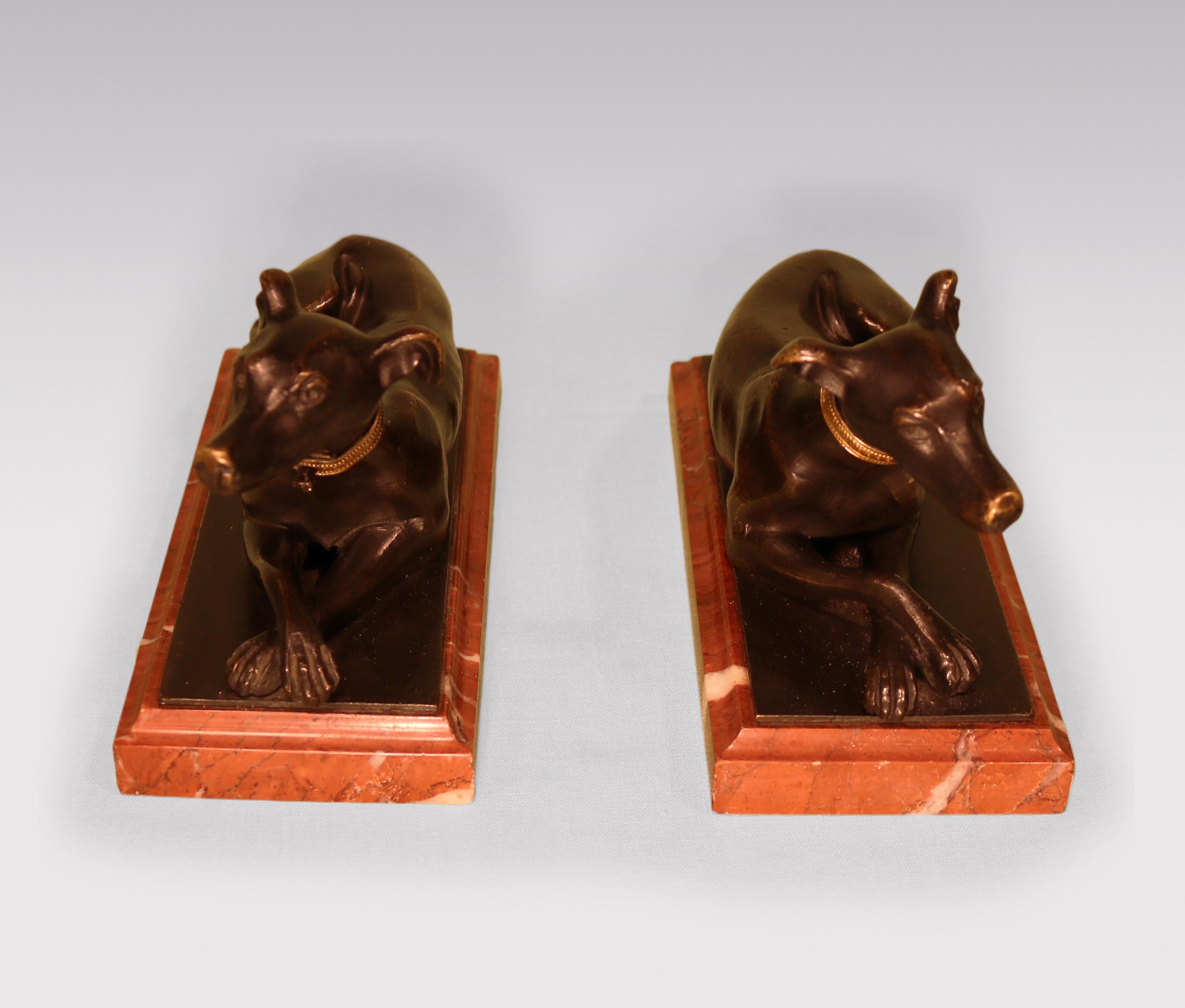 English Antique pair of 19th century bronze hounds on red marble bases. For Sale