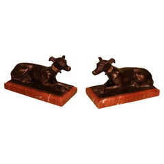 Antique pair of 19th century bronze hounds on red marble bases.
