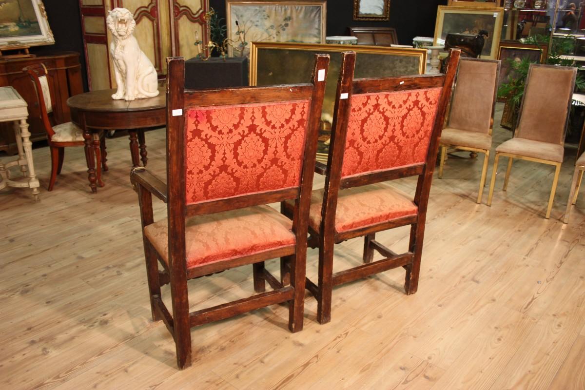 Ancient pair of thrones from central Italy from the 19th century. Furniture carved with decorations on plumes and front in gilding. Feral masks applied on the front of the armrests. Armchairs covered in fabric damask in fair condition with some