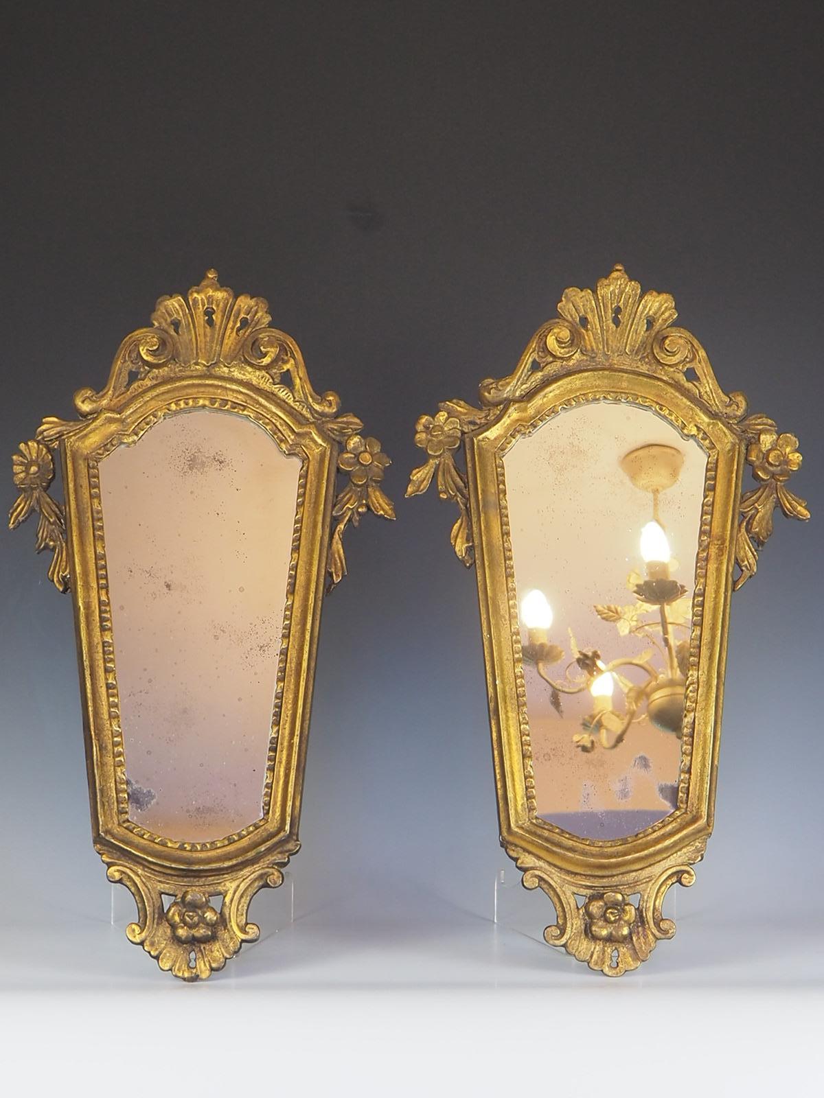 Antique pair of 19th Century Italian Giltwood Mirrors is a stunning addition to any home.

The intricate giltwood frames are highly decorative, featuring ornate carvings and intricate details that are sure to catch the eye. The mirrors themselves