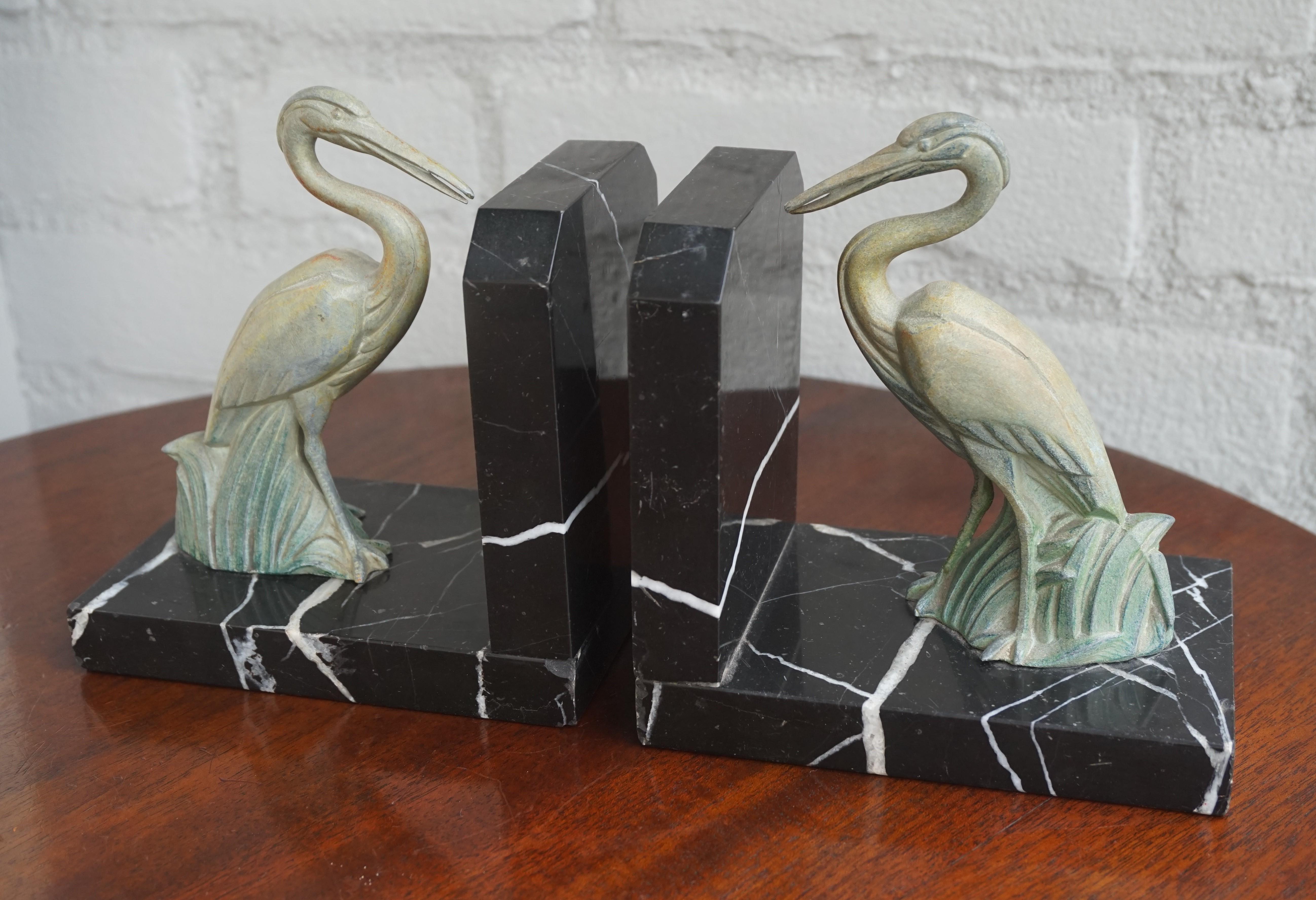 Beautiful and rare pair of sculptural Art Deco bookends.

These small size black and white marble bookends come with a pair of beautifully sculptured, standing storks in the reeds. They are much like the green Art Deco sculptures that Max Le Verrier