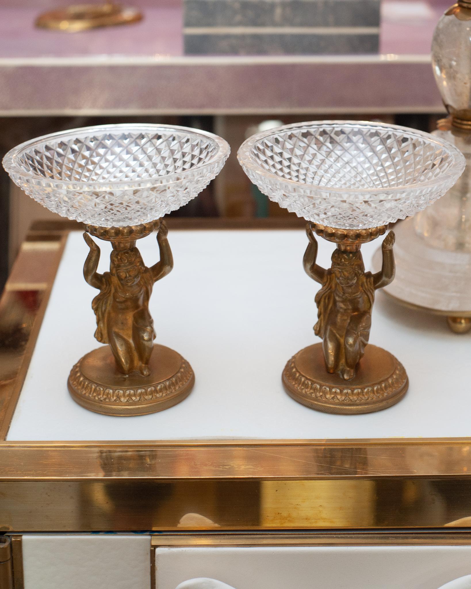 A beautiful pair of antique Baccarat bronze figural compotes with cut crystal bowls. Circa 1900, featuring cherub mounts on a bronze pedestal, these stunning pieces are stamped 
