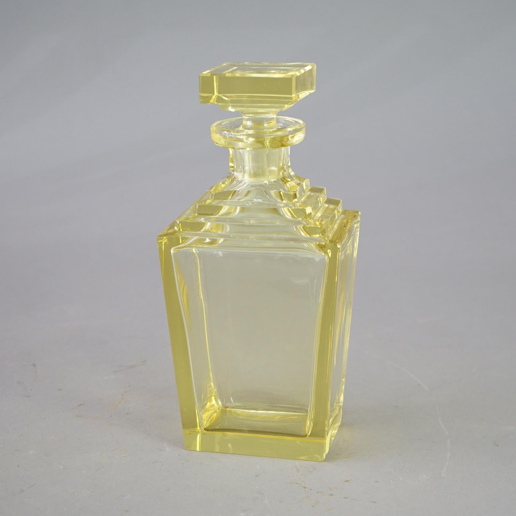 An antique pair of Art Deco decanters in the manner of Baccarat offer citrine crystal construction in tapered form with stepped collar and square stopper, c1920

Measures- 10''H x 4.5''W x 3.25''D