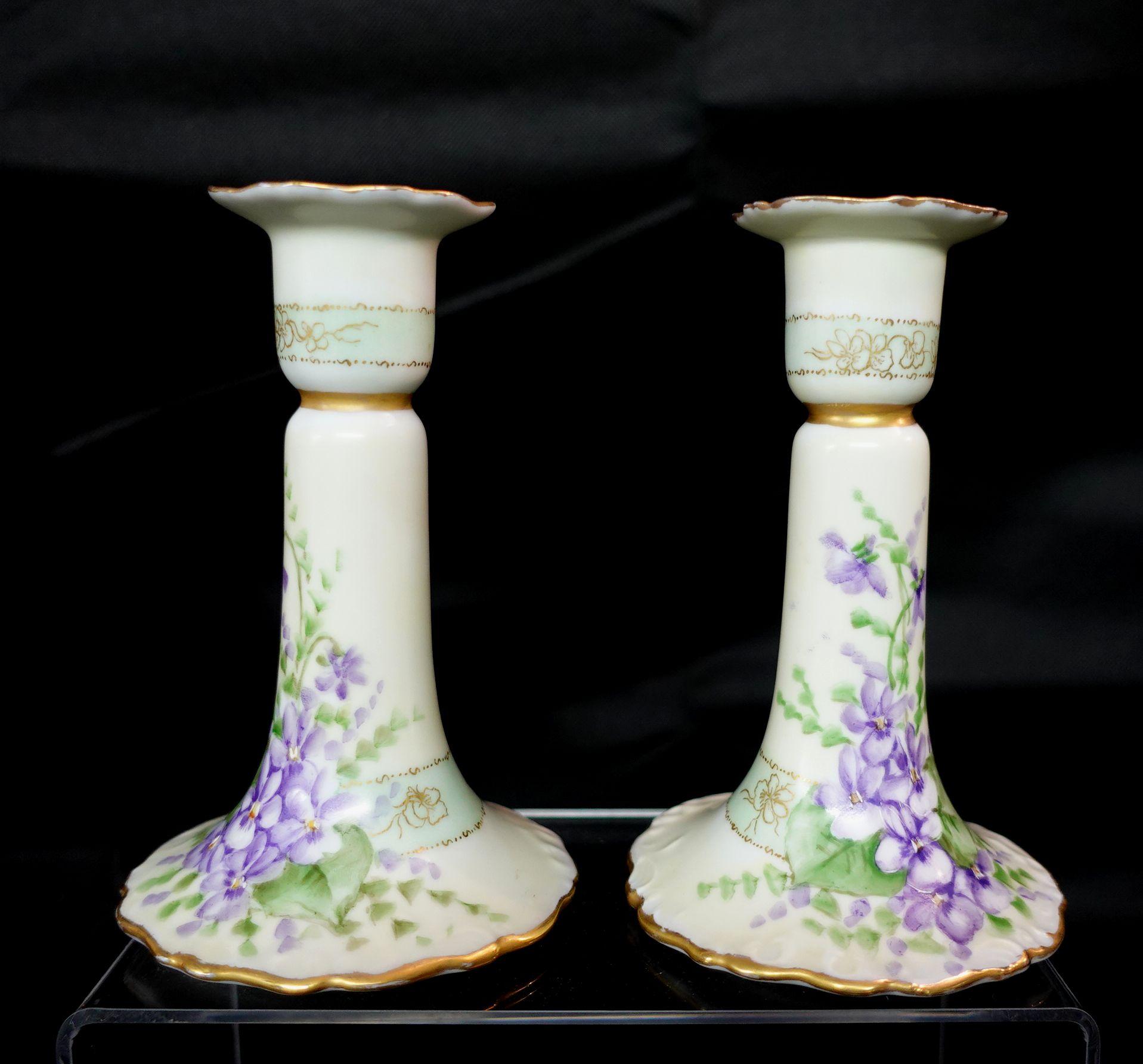 A wonderful antique pair of bavarian German candle sticks with floral pattern and gilt line art finishing.
   