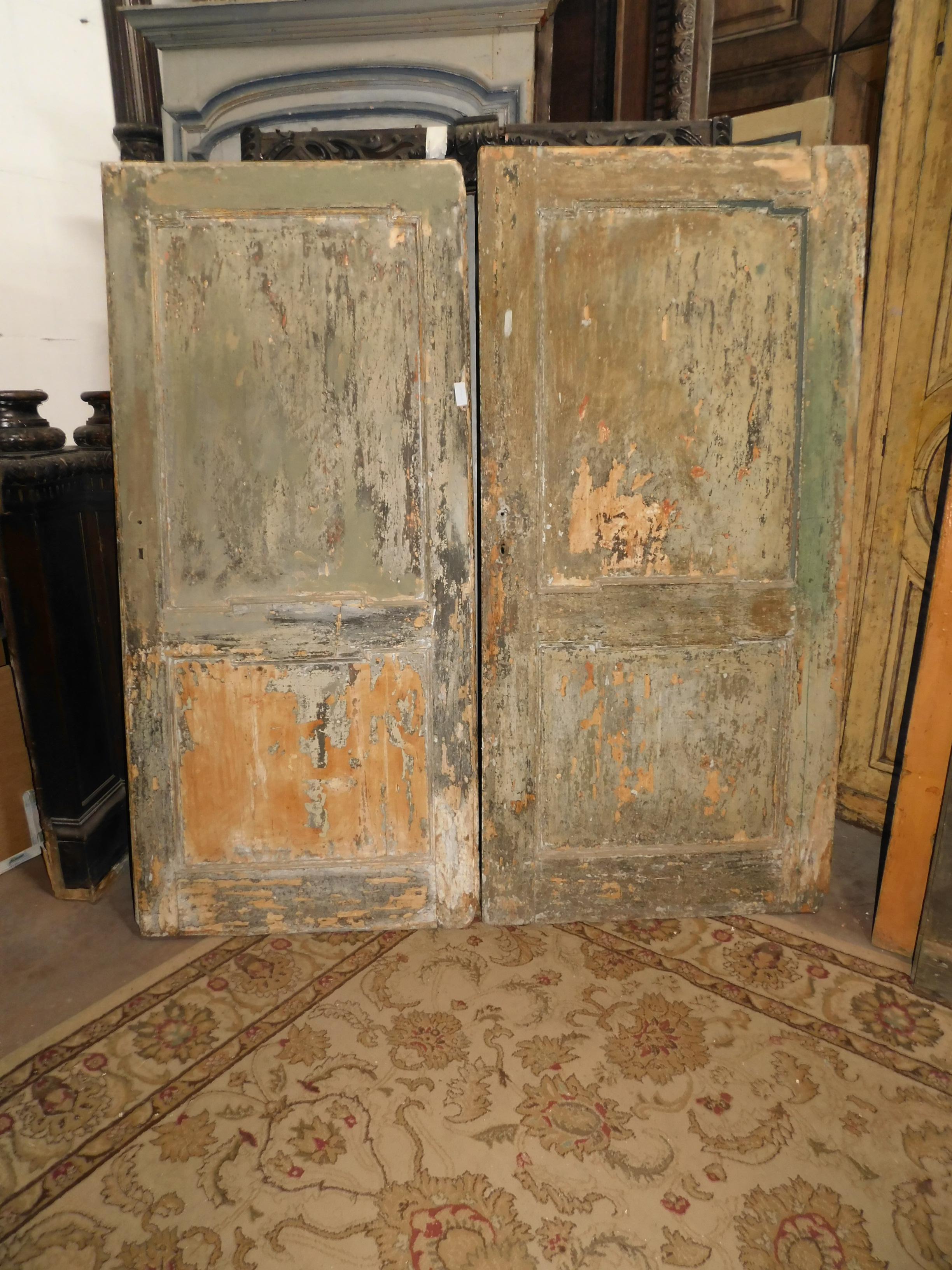 Ancient pair of doors, with panels carved in blond wood, with an amazing first lacquered patina (the color and finish are given by the centuries of life of the doors, it is the original color with which they were born), produced in pairs in the 18th