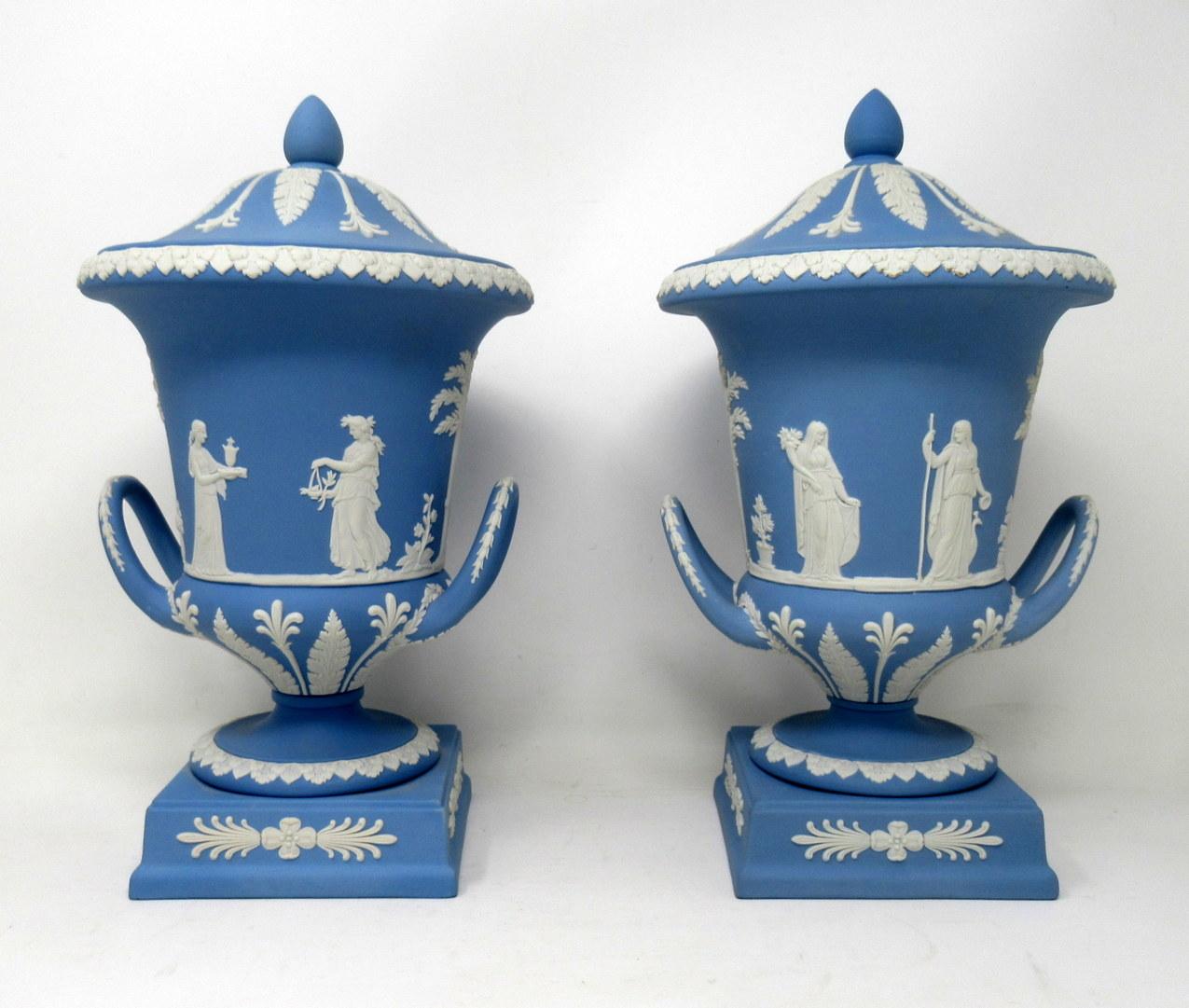An exceptionally fine example of a pair of English Jasperware Wedgwood urns of good size proportions, mid-20th century.

The twin arched handle Campana form urn decorated in relief depicting neoclassical scenes of adult figures and children on