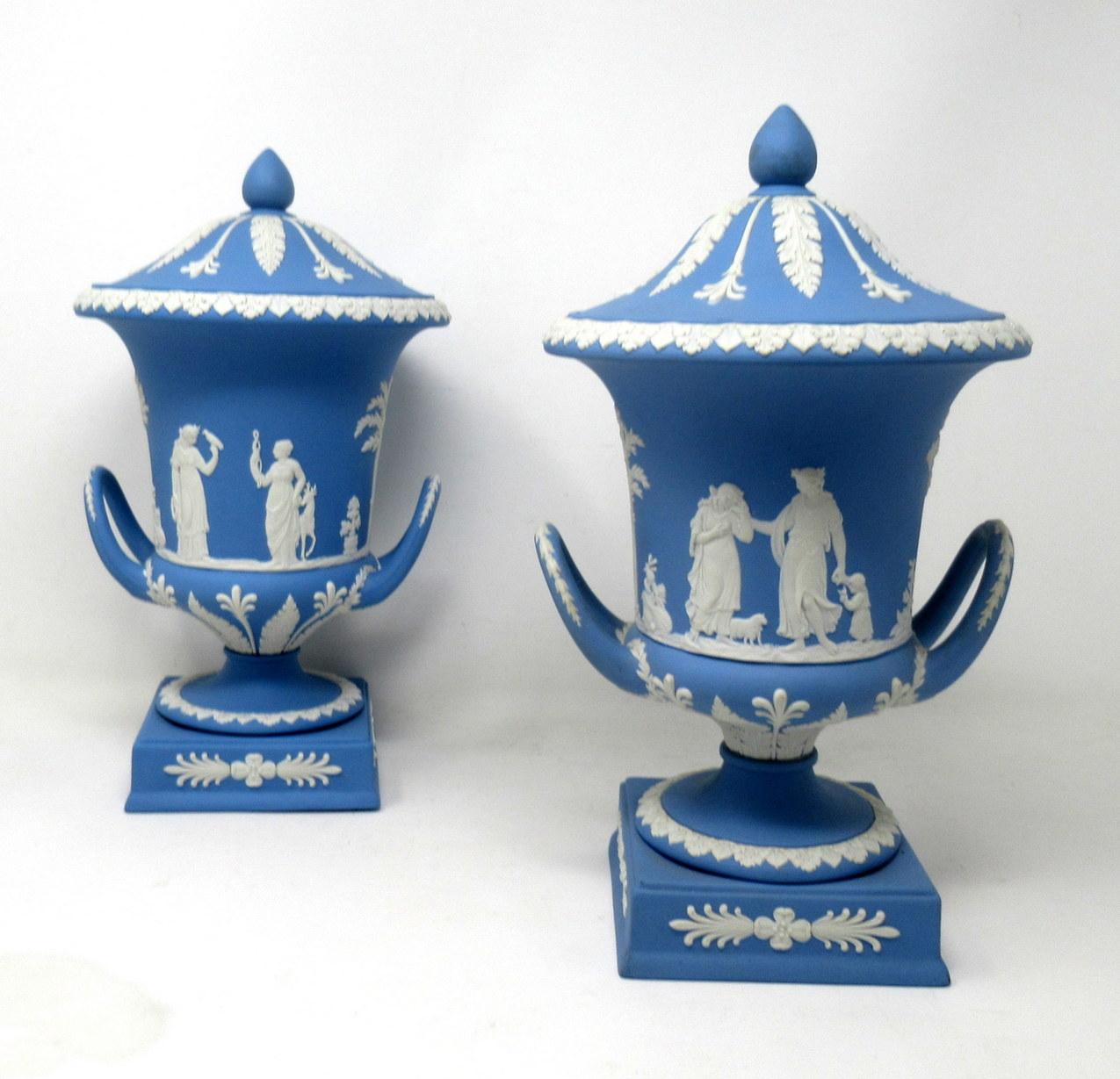An exceptionally fine example of a pair of English Jasperware Wedgwood urns of good size proportions, mid-20th century.

The twin arched handle Campana form urn decorated in relief depicting neoclassical scenes of adult figures and children on