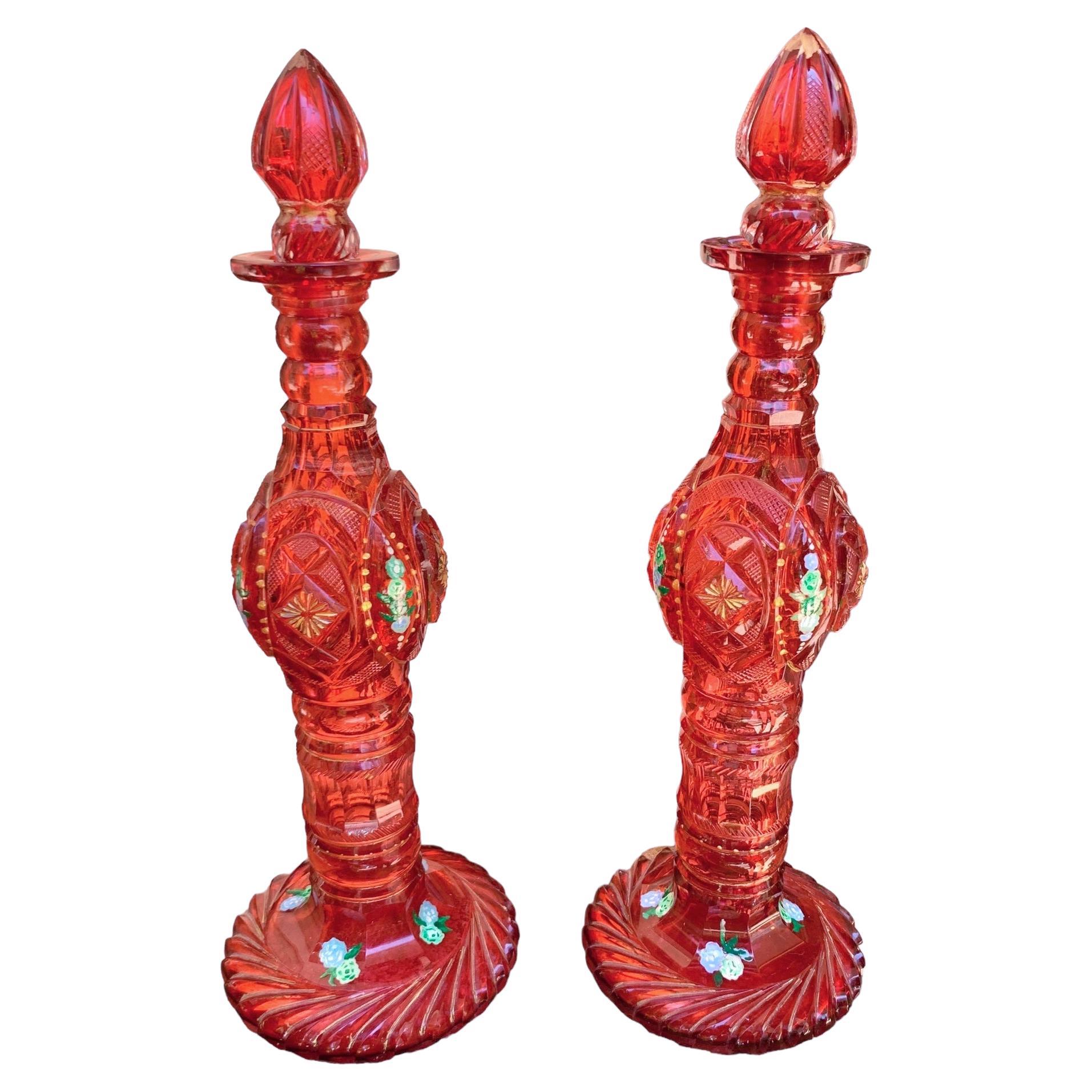 Stunning pair of decanters in cranberry cut glass

Deep-cut all around in decaorative shapes and patterns

Brilliant hand-work, a fine example of the highest quality antique Bohemian glass

Bohemia, 19th Century

Height 29 cm