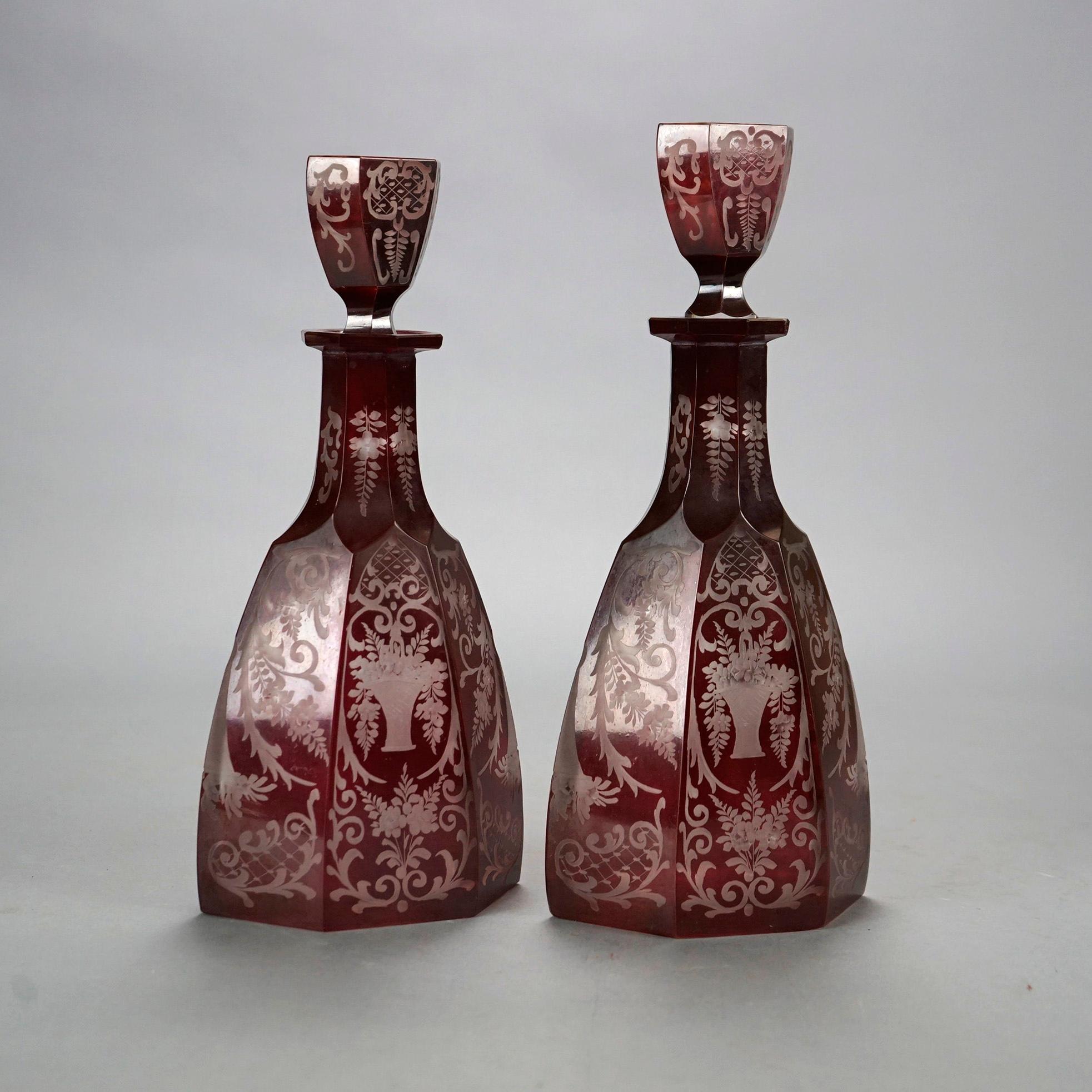 An antique pair of Bohemian glass decanters offers faceted form with cut to clear floral and urn design, 19th century

Measures-
Left 11.75''H x 5.5''W x 3.5''D;
Right 12.25''H x 5.5''W x 3.5''D.
