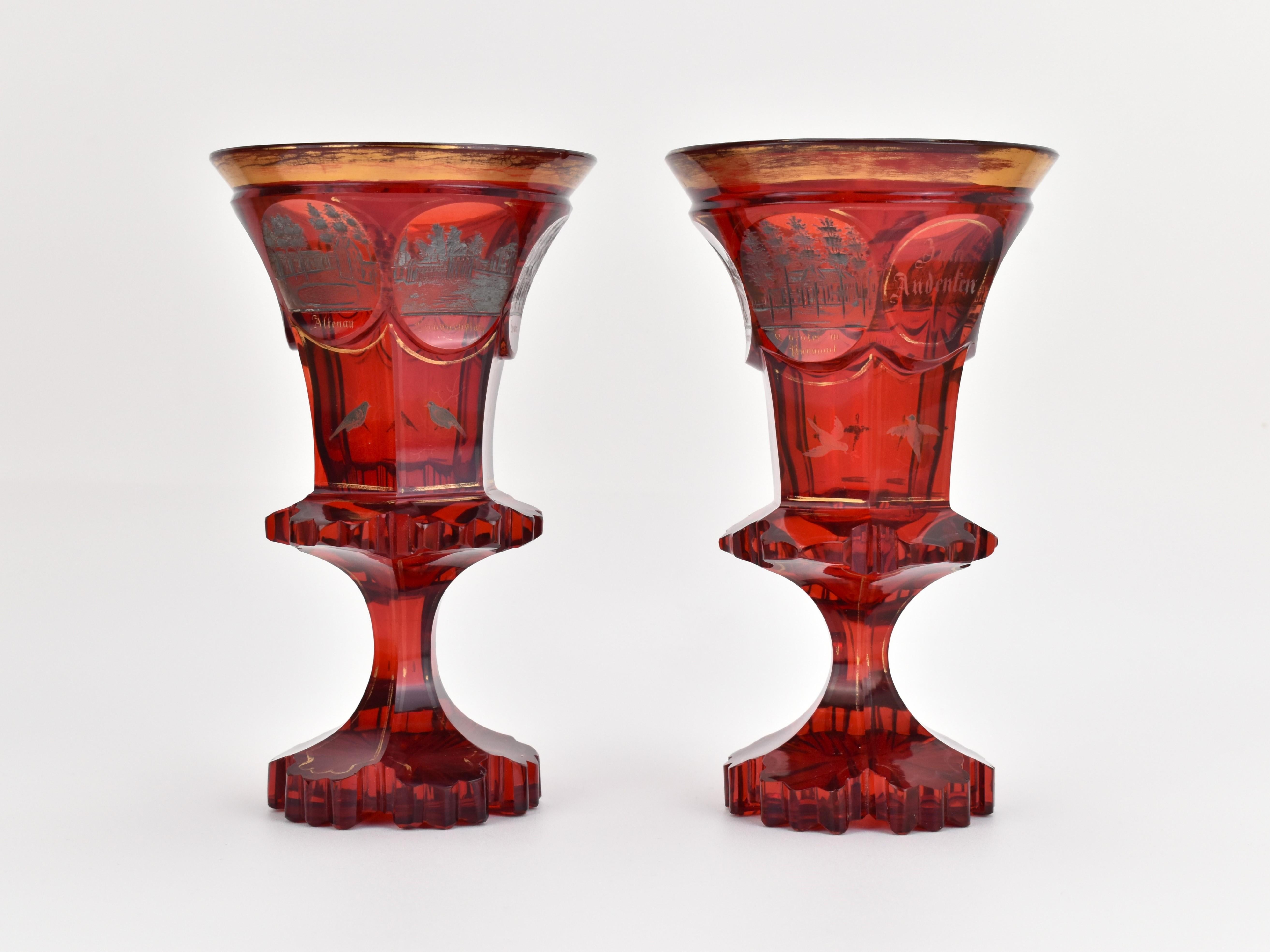 This rare pair of goblets, crafted in Bohemia circa 1840, exemplifies the finest achievements of mid-19th-century Biedermeier glasswork. Made from deep ruby red cut glass, each goblet with a circular gilded rim and an eight-sided body, featuring