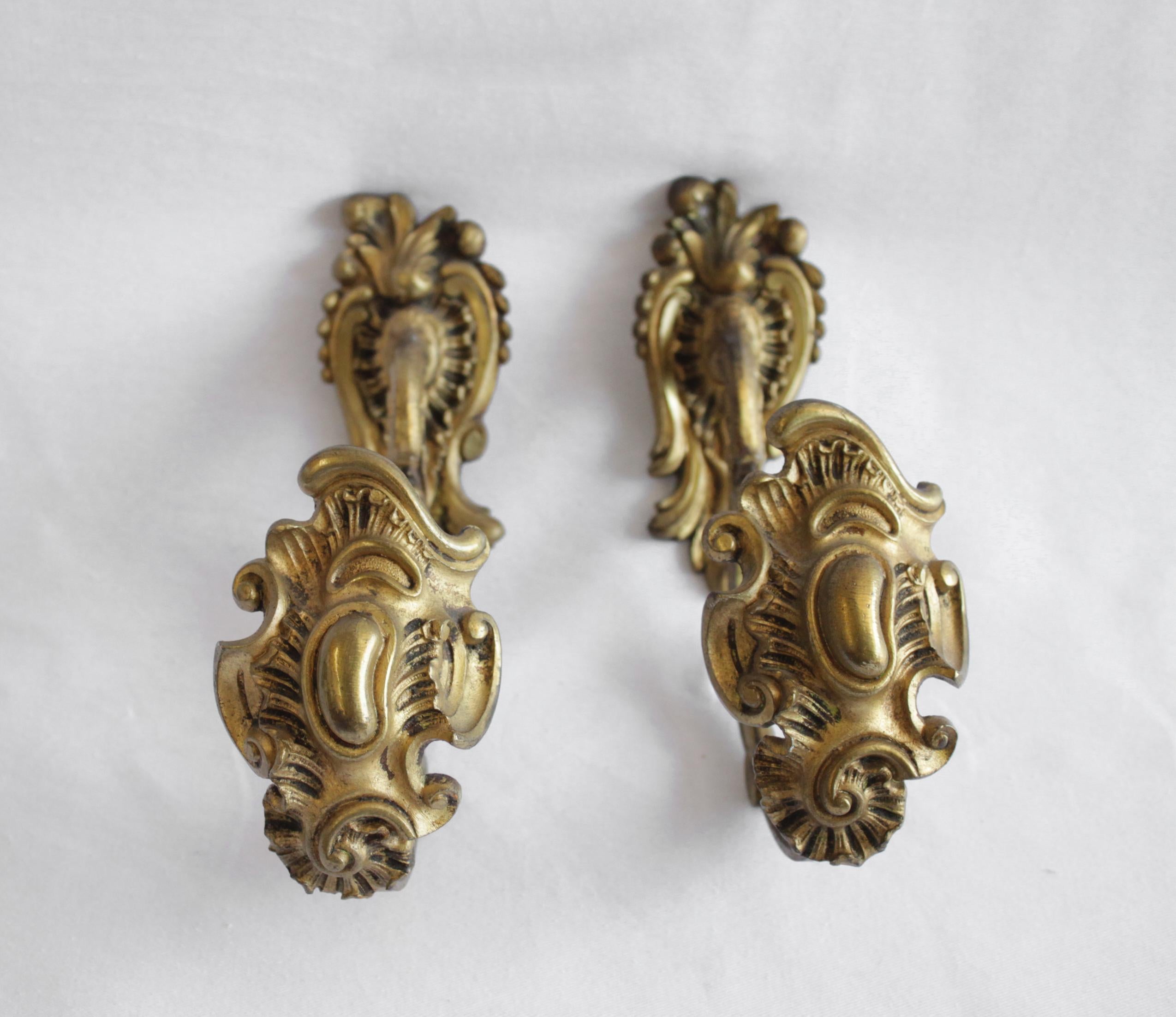 Antique brass curtain tie backs in Rococo style.
These easily attach to the wall with a couple screws.
French, circa 19th century
Measures: 3.25