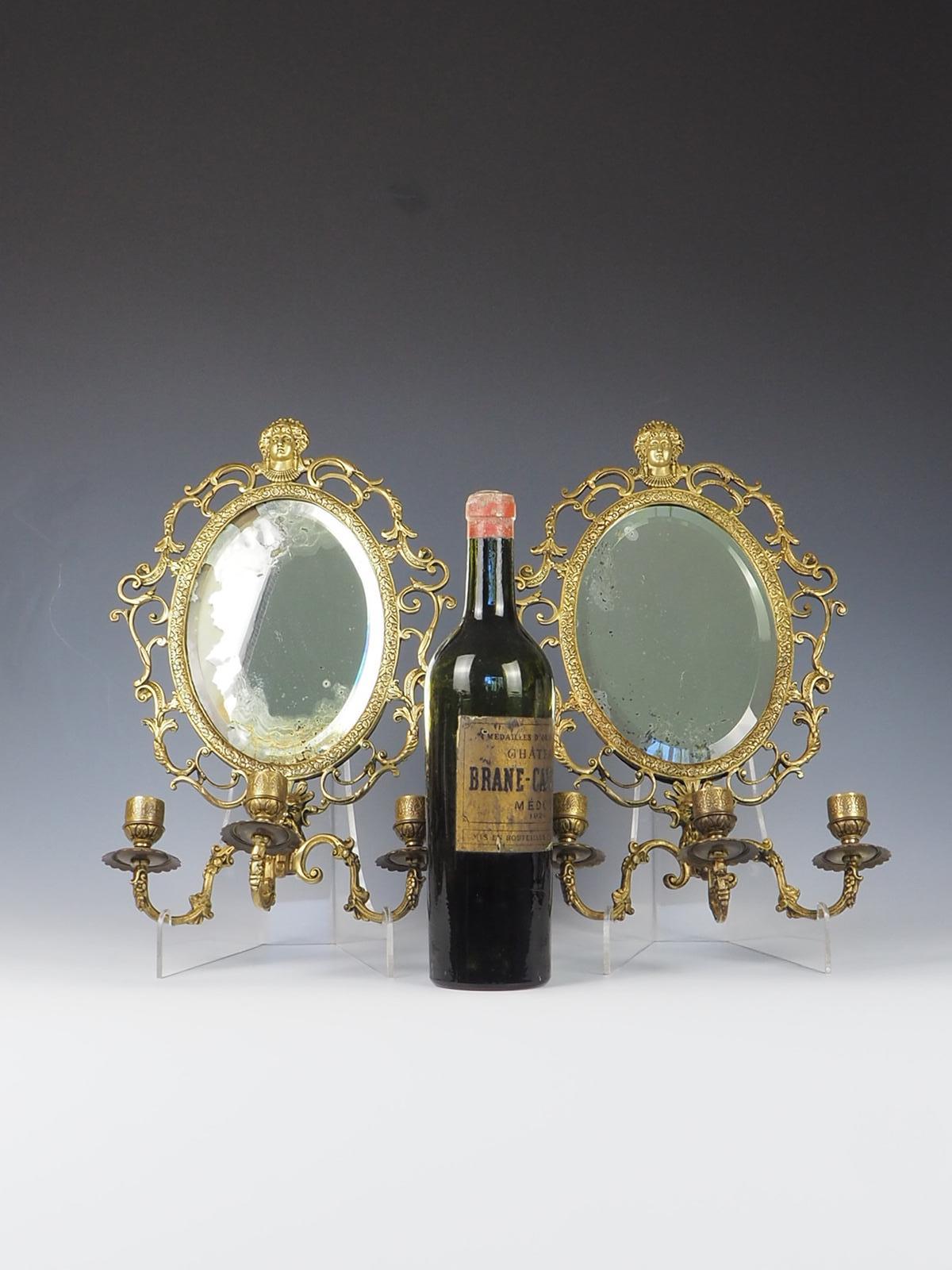 Antique Pair of Brass Wall Sconce Mirrors, this exquisite set showcases a captivating blend of elegance and functionality. Crafted during the Egyptian revival period, these wall mirrors exude a timeless charm that will enhance any interior space.