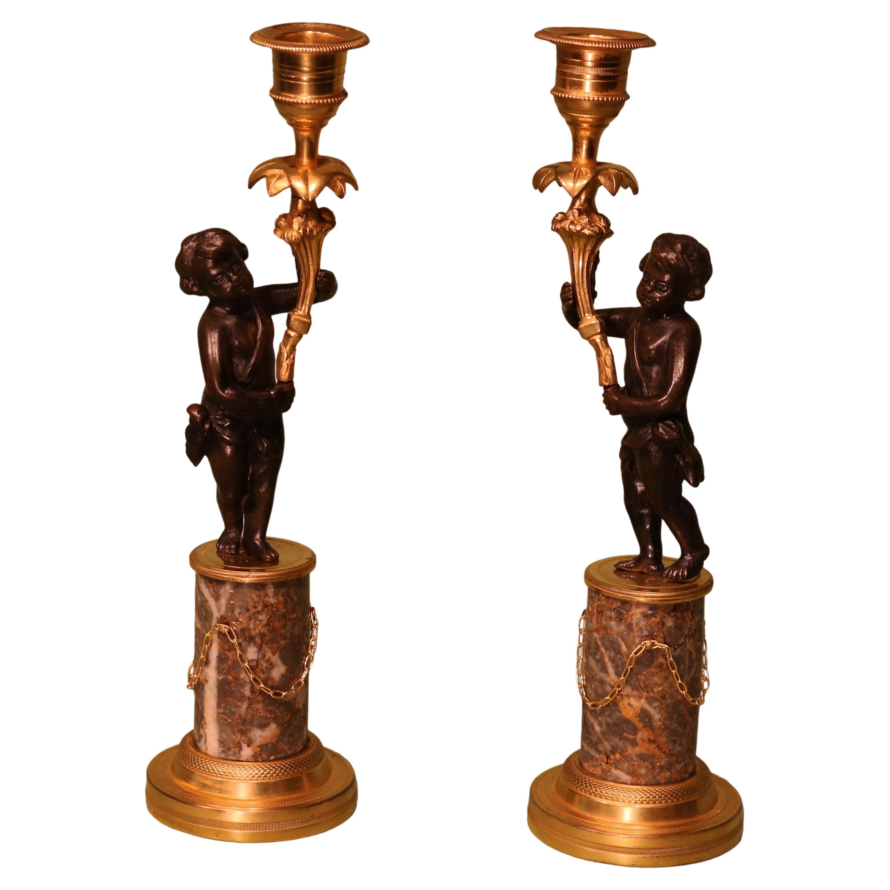 Antique Pair of Bronze and Ormolu Cherub Candlesticks For Sale