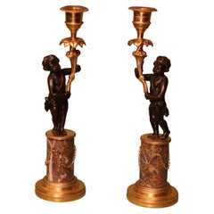 Paire de chandeliers anciens en bronze et bronze doré