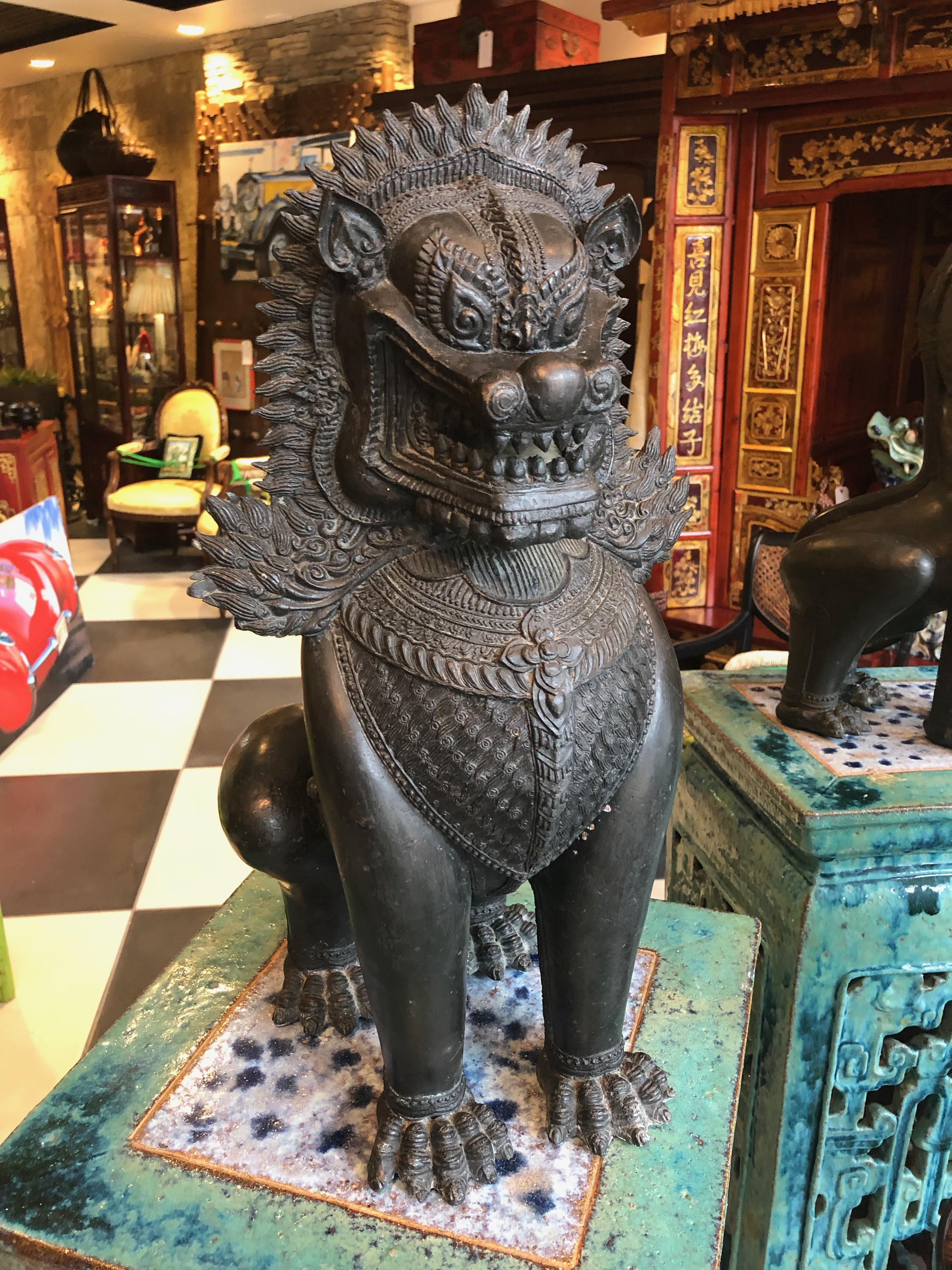 These Foo dogs are bronze statues from Thailand fierce Mythical lions ornamental in jewelry across their chests, baring their teeth to scare away bad spirits and bad luck. The 