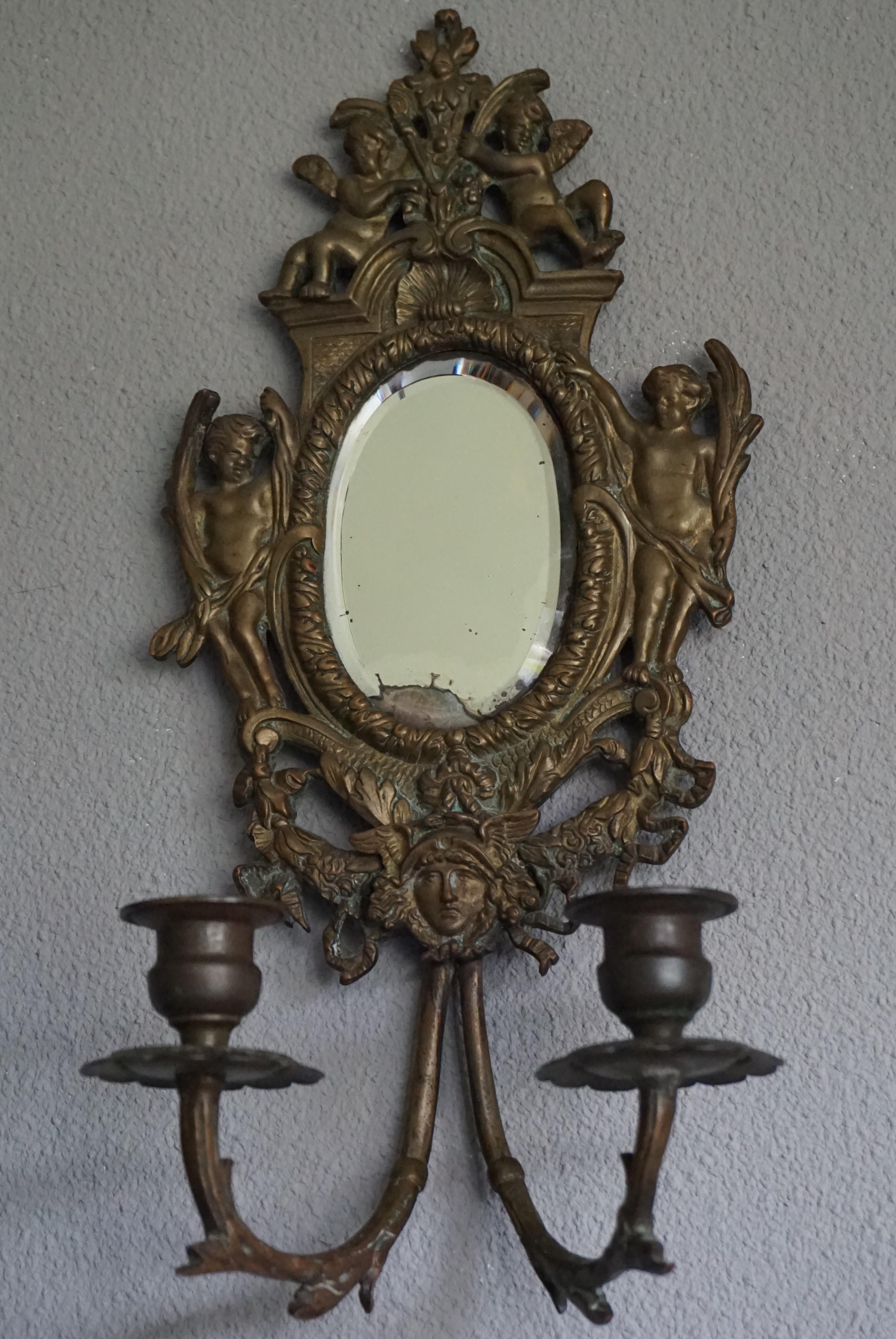 Beautiful and practical size pair of Renaissance Revival candle sconces.

This antique pair of bronze sconces will look great above a side table, your bedside cabinets or in a hallway on either side of a mirror. This pair comes with the original,