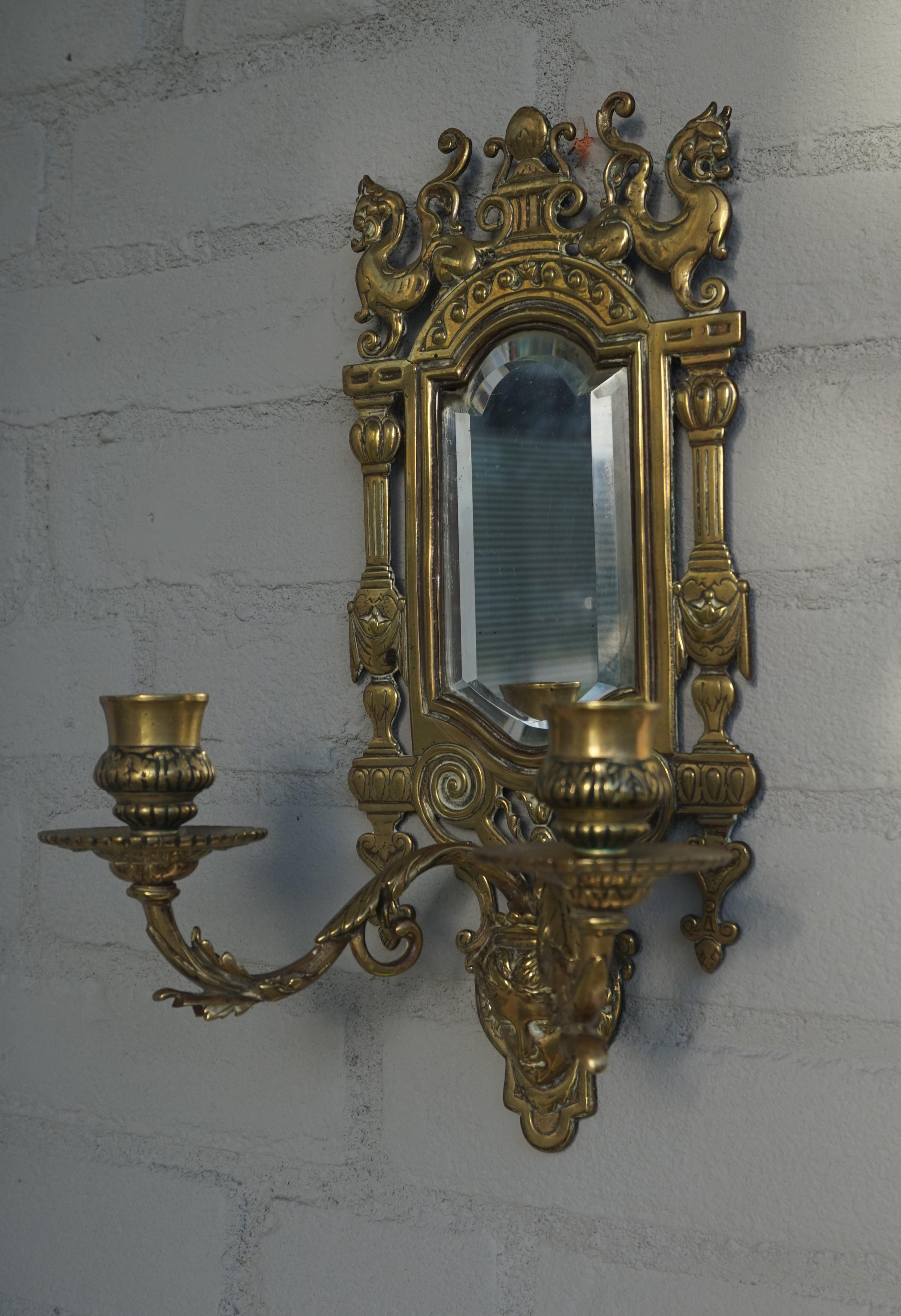 Beautiful design and practical size pair of Renaissance style candle sconces.

This antique pair of bronze sconces will look great above a side table, your bedside cabinets or in a hallway on either side of a mirror. This pair comes with the