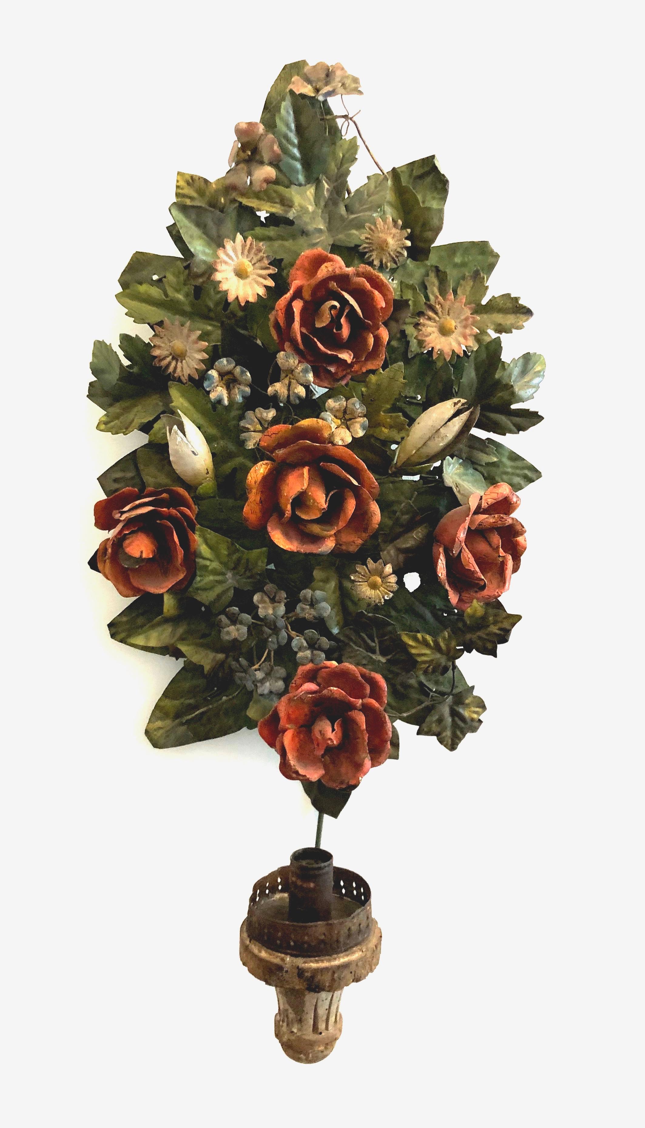 Charming pair of candle appliques made of different colored metal flowers and foliage. Individual flowers and leaves have been tied to a metal frame. The candleholders are made from wood and
metal.