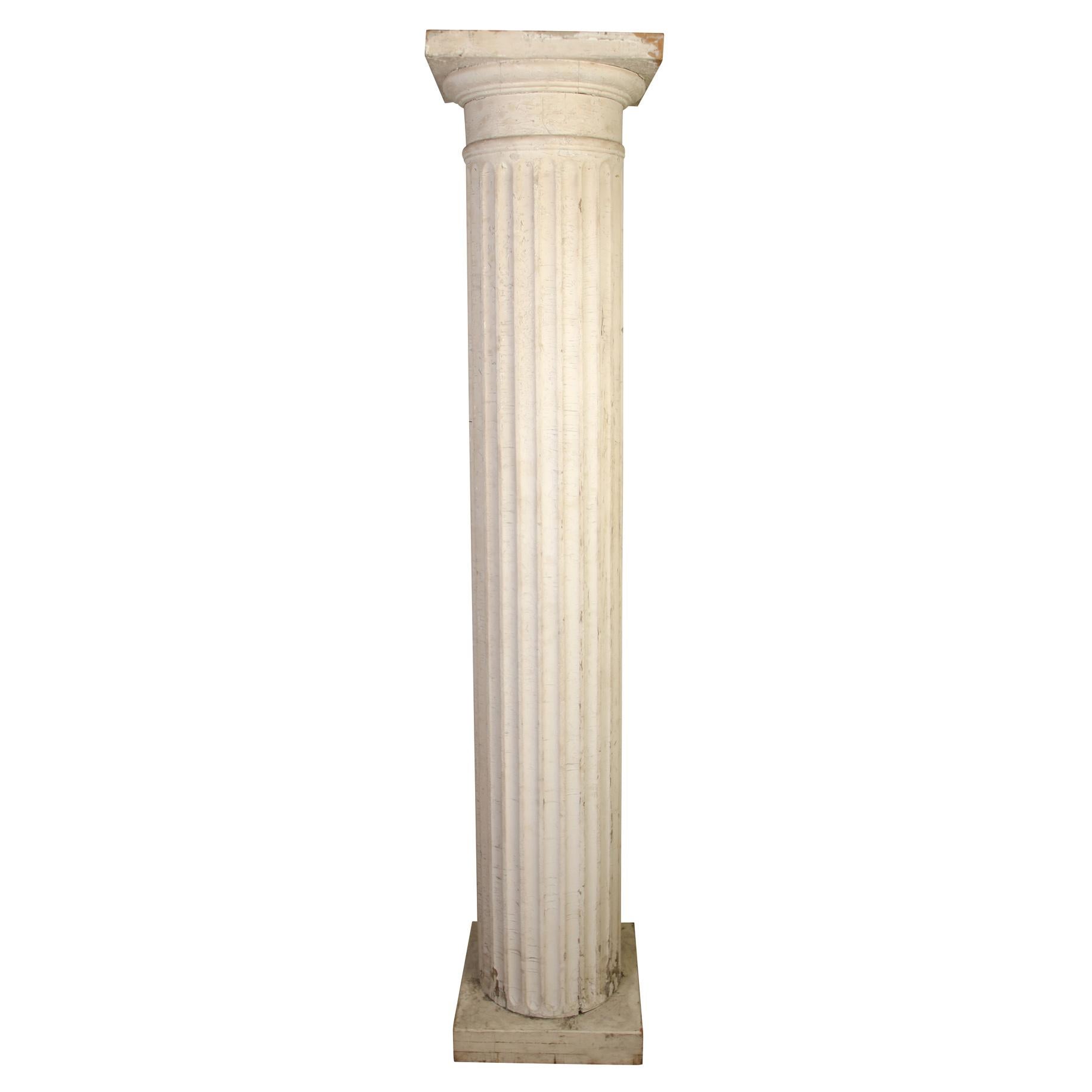 An impressive pair of antique painted and carved white fluted columns. Column diameter measures 14