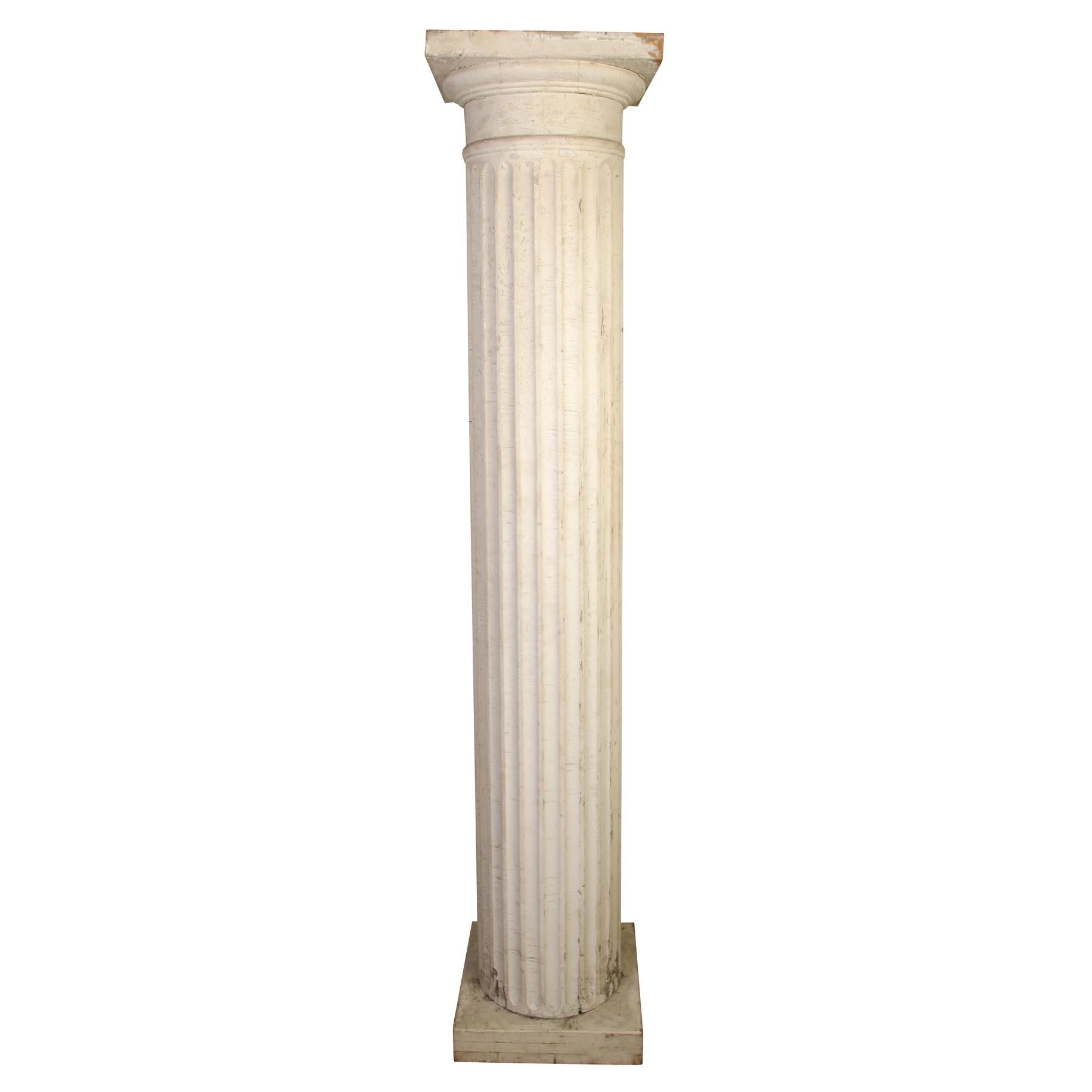An impressive pair of antique painted and carved white fluted columns. Column diameter measures 14