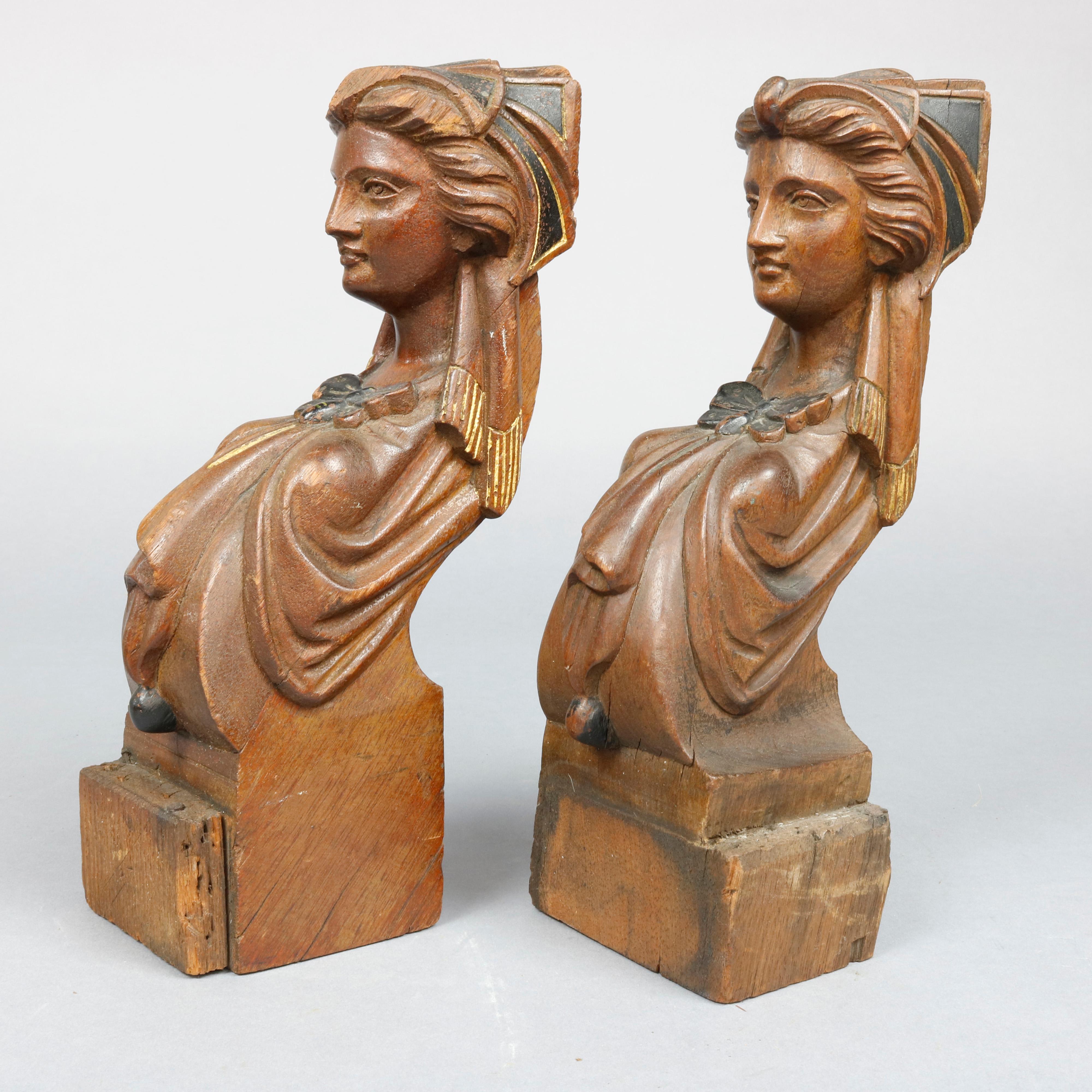 An antique pair of figural carved walnut architectural elements in the attributed to Jelliff offer portrait sculptures of women with butterfly dress having gilt and ebonized highlights, circa 1890

Measures- 10.63