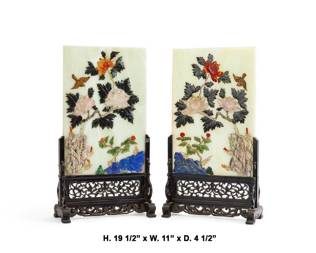 Fabulous and opposing pair of Chinese finely hand-carved gemstone table screens with Rose Quartz, Jade, Agate, Tiger Eye, Coral, Lapis Lazuli, Malachite and other gemstones supported by an intricately carved fretwork wood stand.
Both panels are